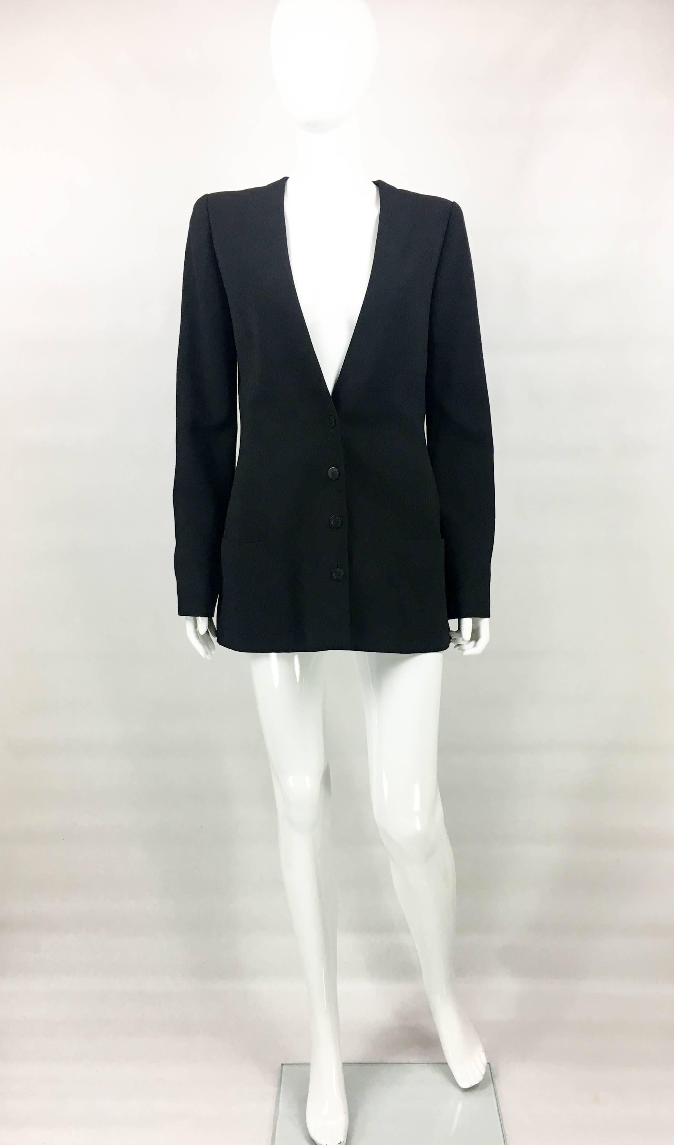 Vintage Chanel Black Wool Jacket. This elegant piece by Chanel was created for the 2003 Spring / Summer Collection. Made in light wool, this single-breasted jacket has 4 buttons down the front and 2 on each cuff. It also has 2 front pockets. Silk