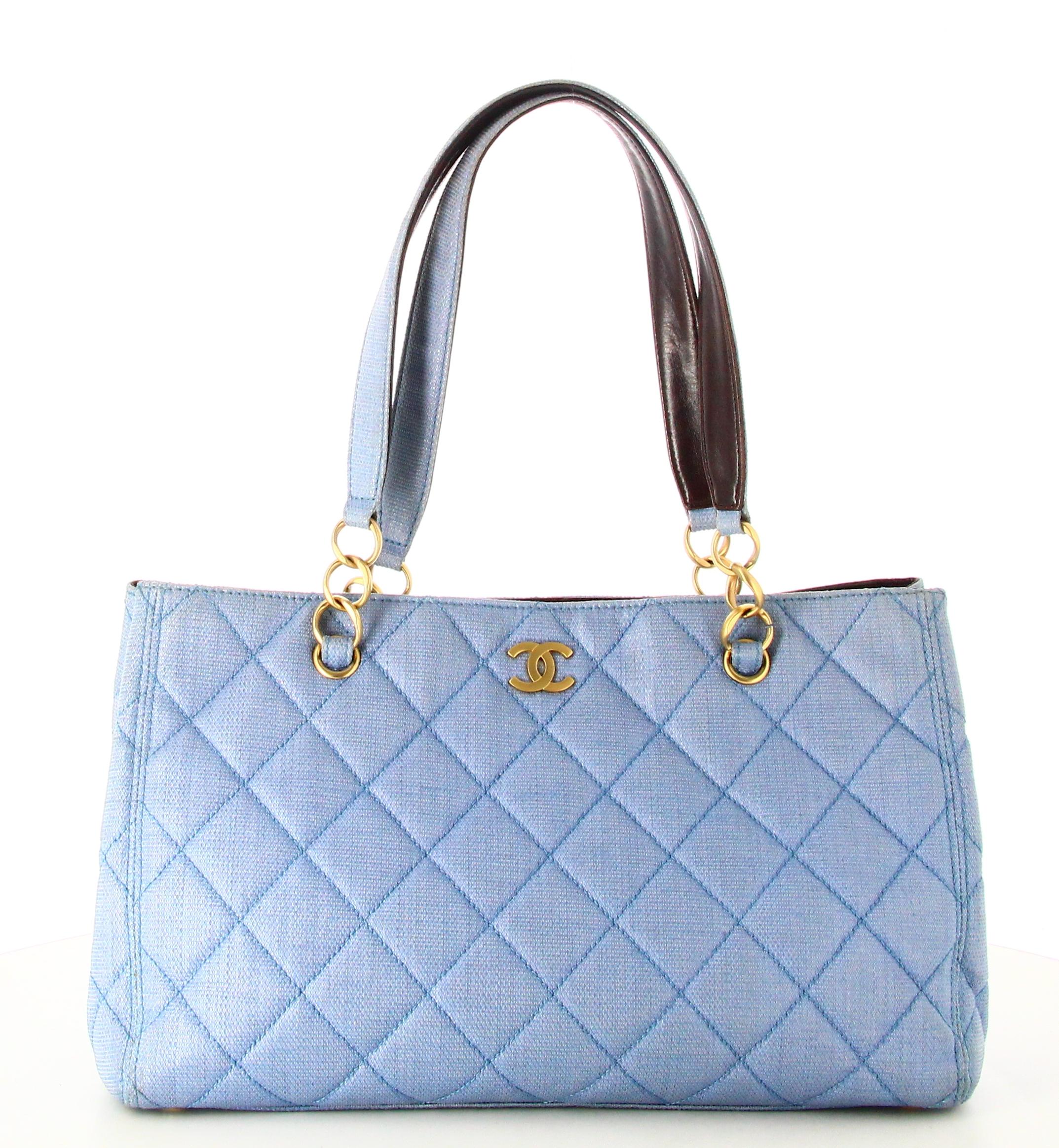 2003 Chanel Quilted Handbag Sky Blue 

- Good condition. Shows slight signs of wear over time.
- Chanel Handbag 
- Quilted fabric
- Two small straps 
- Inside: brown logo lining