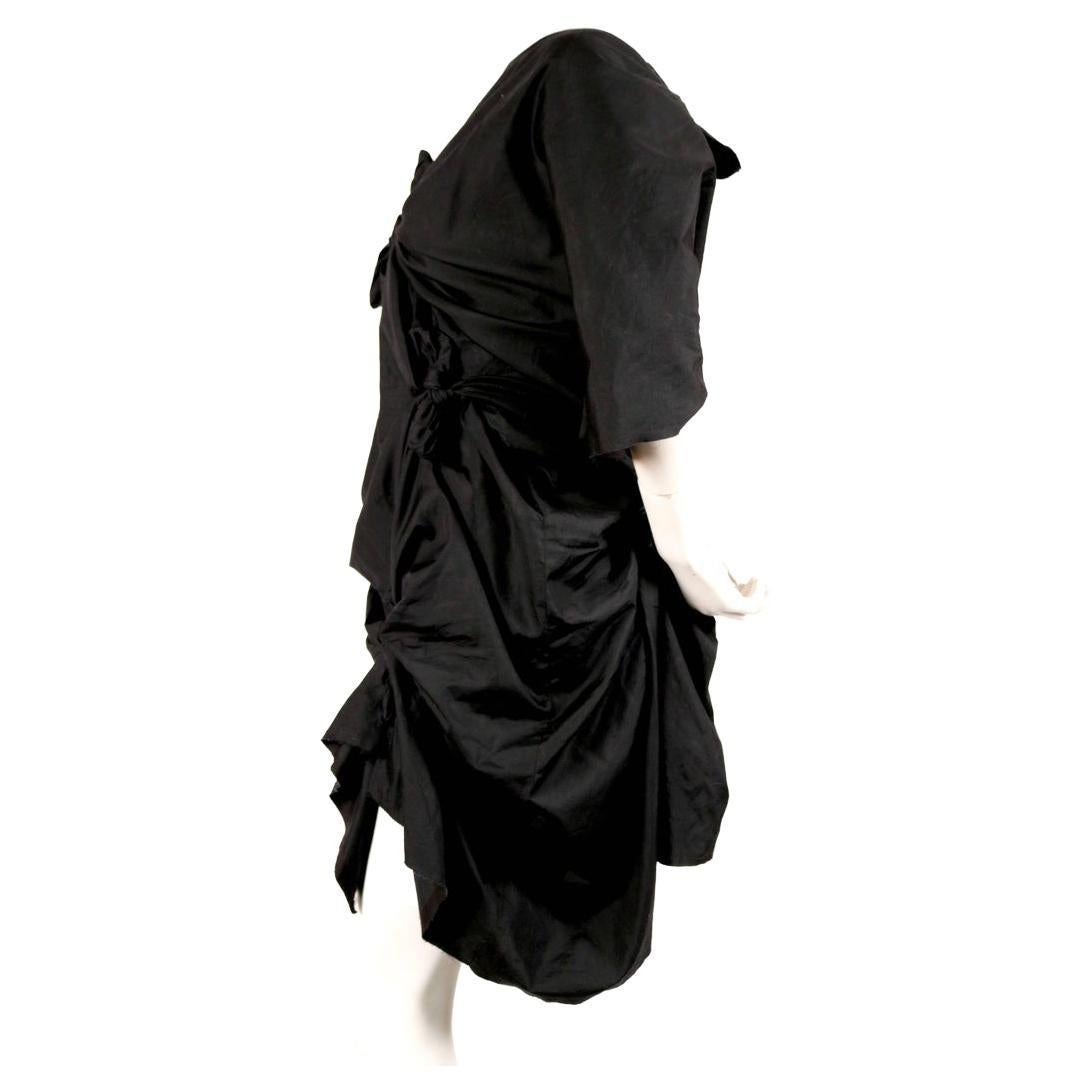 Jet-black cotton, knotted dress with raw edges designed by Rei Kawakubo for Comme des Garcons dating to spring of 2003. Very similar pieces were seen on the runway. Size M. Approximate length as currently knotted 34