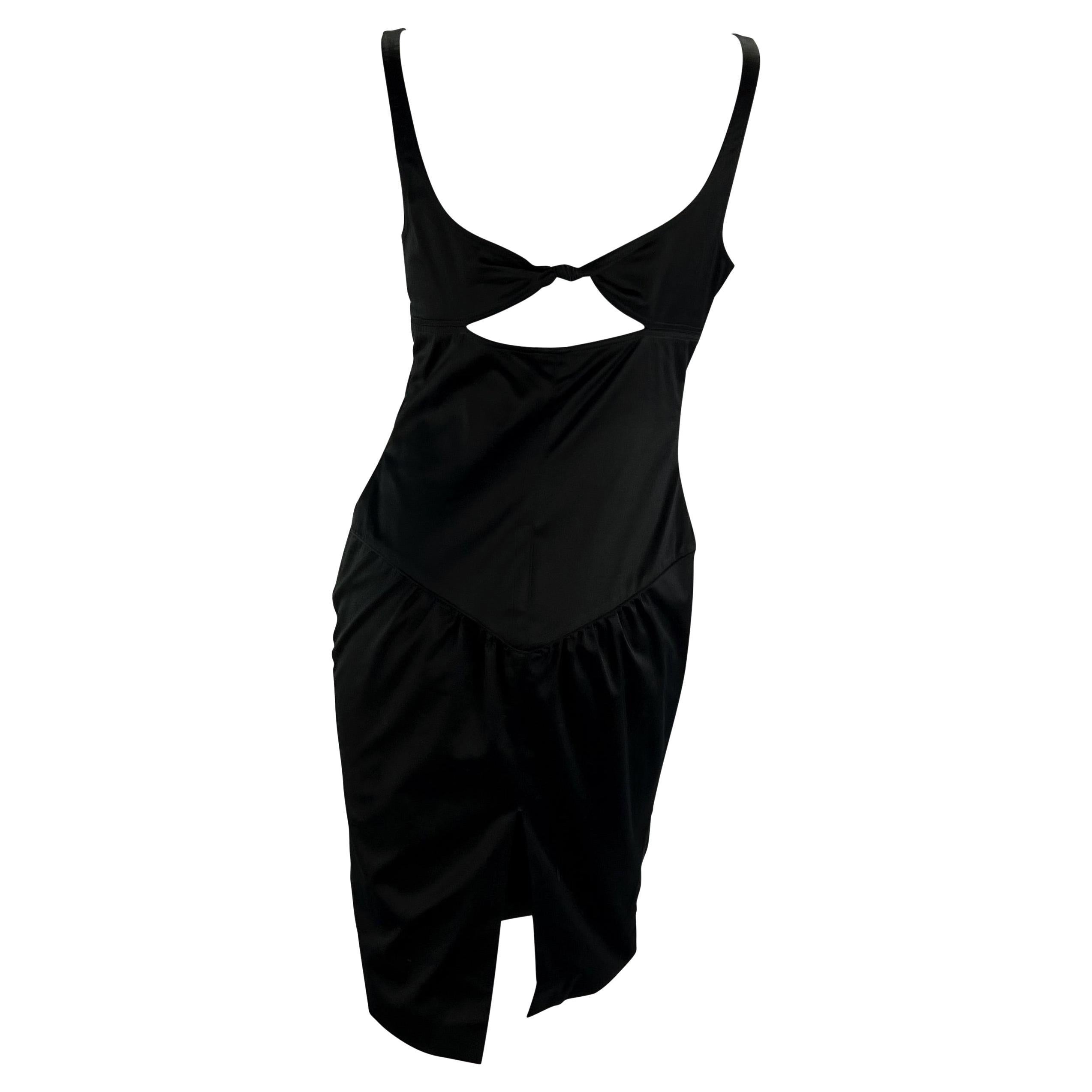 TheRealList presents: a beautiful black Gucci cutout dress, designed by Tom Ford. From the 2003 collection, this little black dress is constructed entirely of a silk blend and features a semi-sweetheart neckline, a cut out at the mid-back, and a