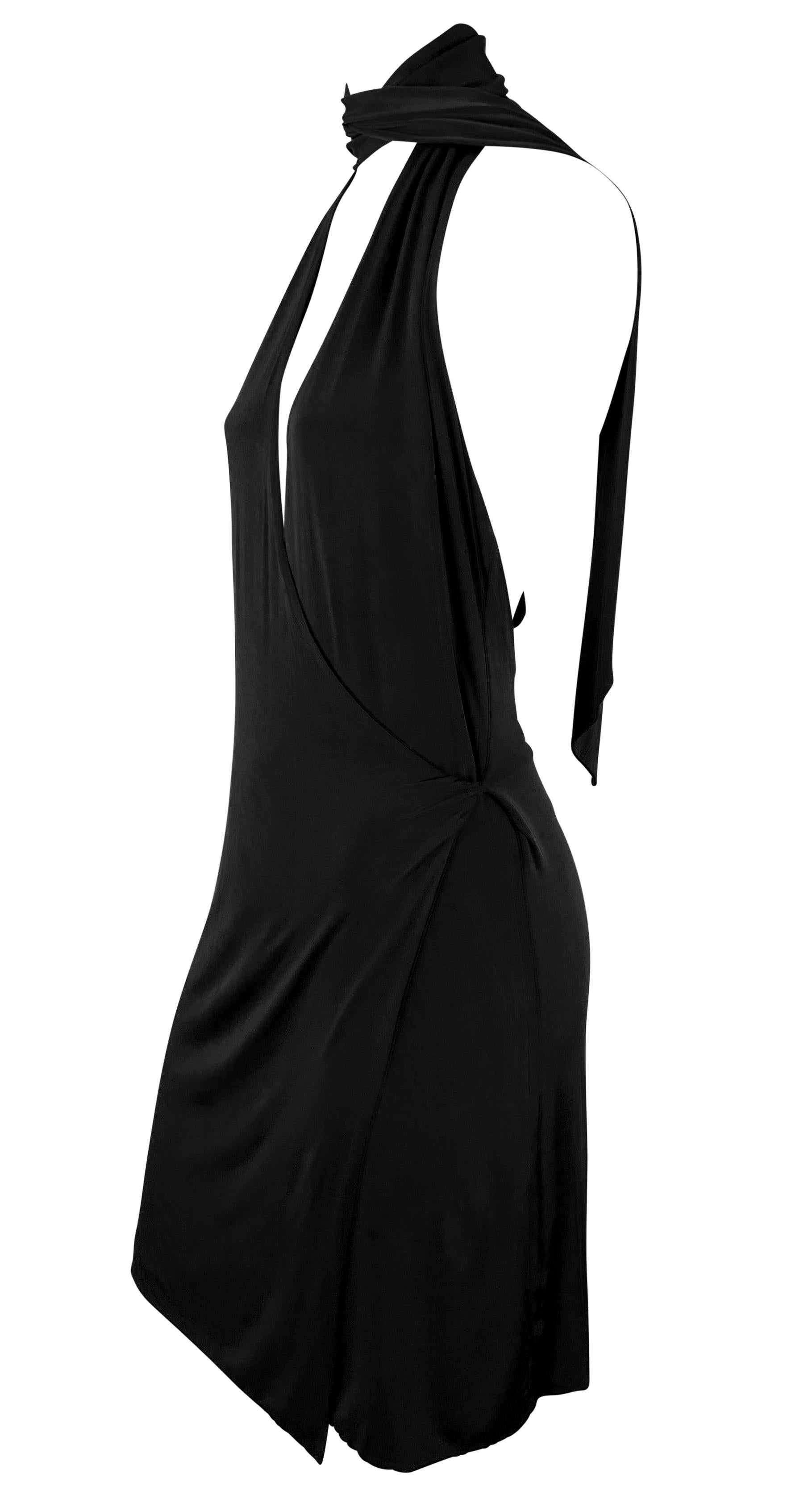 This sleek and sultry mini dress from Tom Ford’s time at Gucci features a bodycon silhouette crafted in soft viscose. The design showcases a halter neckline with a dramatic wrap detail that ties at the back, accentuating an open back and daring