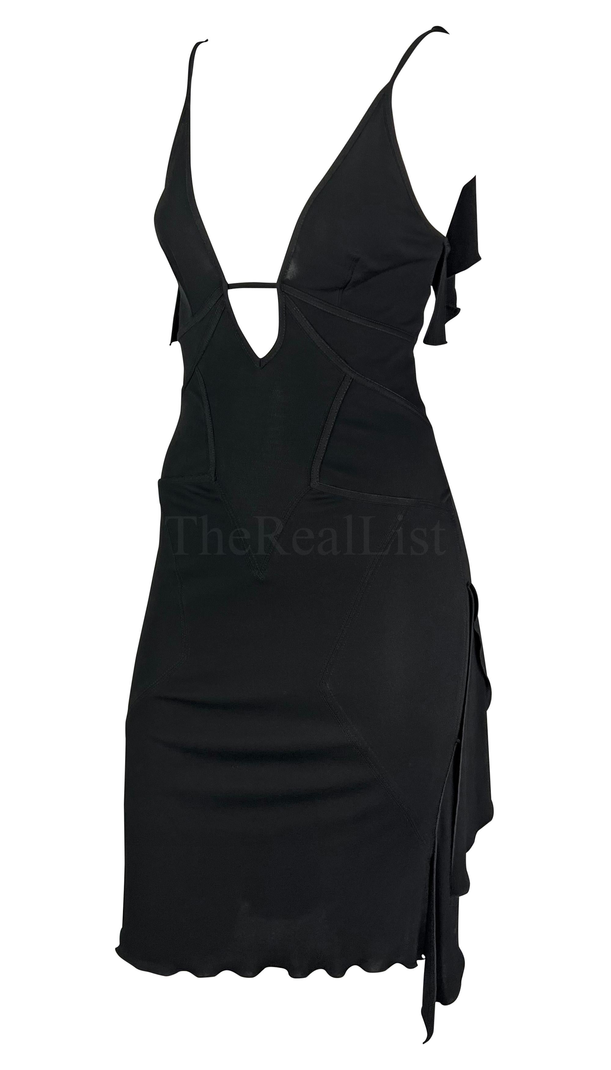 Presenting a chic black ruffle Gucci slip dress, designed by Tom Ford. From 2003, a plunging neckline, spaghetti straps, and an alluring exposed back meet artfully placed straps, creating a perfect silhouette. The dress is made complete with draped