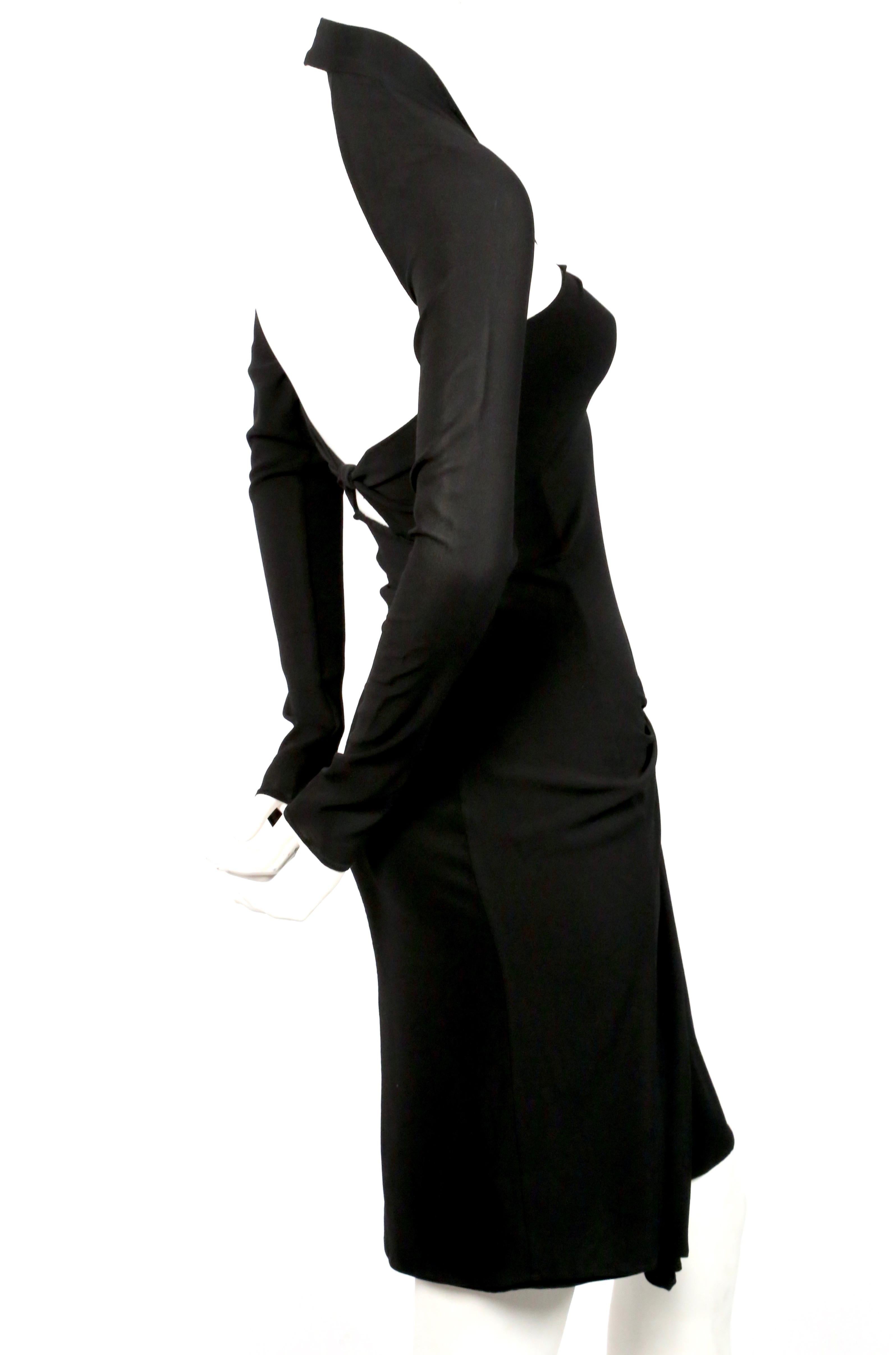 Slinky, jet-black, silk dress with cut-outs at bodice and ruching at hip designed by Tom Ford for Gucci dating to 2003. Italian size 40. Best fits a US 2-4. Approximate measurements: bust 29