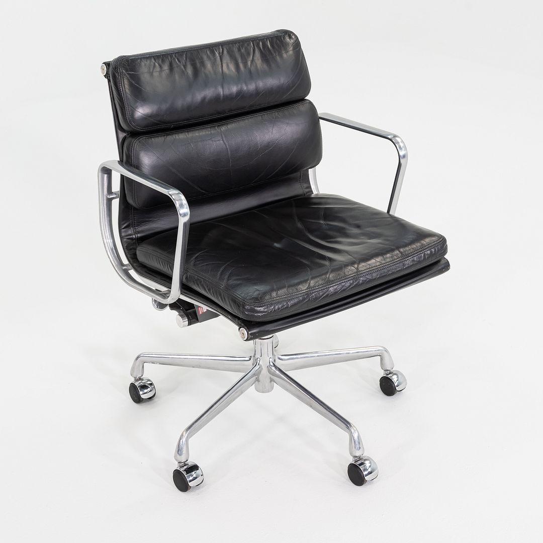 This is an Eames Aluminum Group Soft Pad Management Desk Chair, Model EA435, originally designed by Charles and Ray Eames for Herman Miller in 1969. These examples date to the year 2003. Their design features a cast aluminum frame with an adjustable