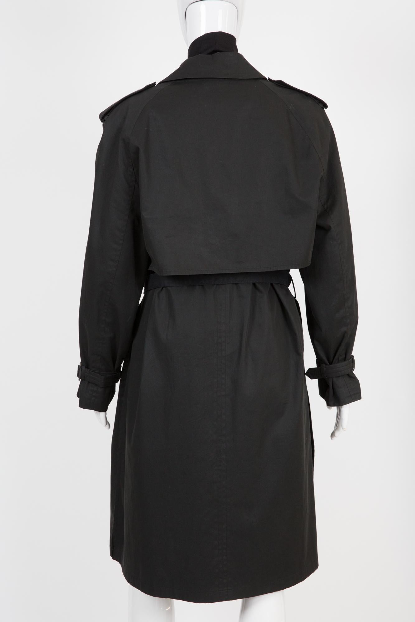 Hermes by Martin Margiela black trench coat featuring a black gabardine flared trench coat, slits detailing at sides, detachable cape and sleeves at back and a seperated belt. (see attached image Margiela book)
Circa Summer 2003
In good vintage