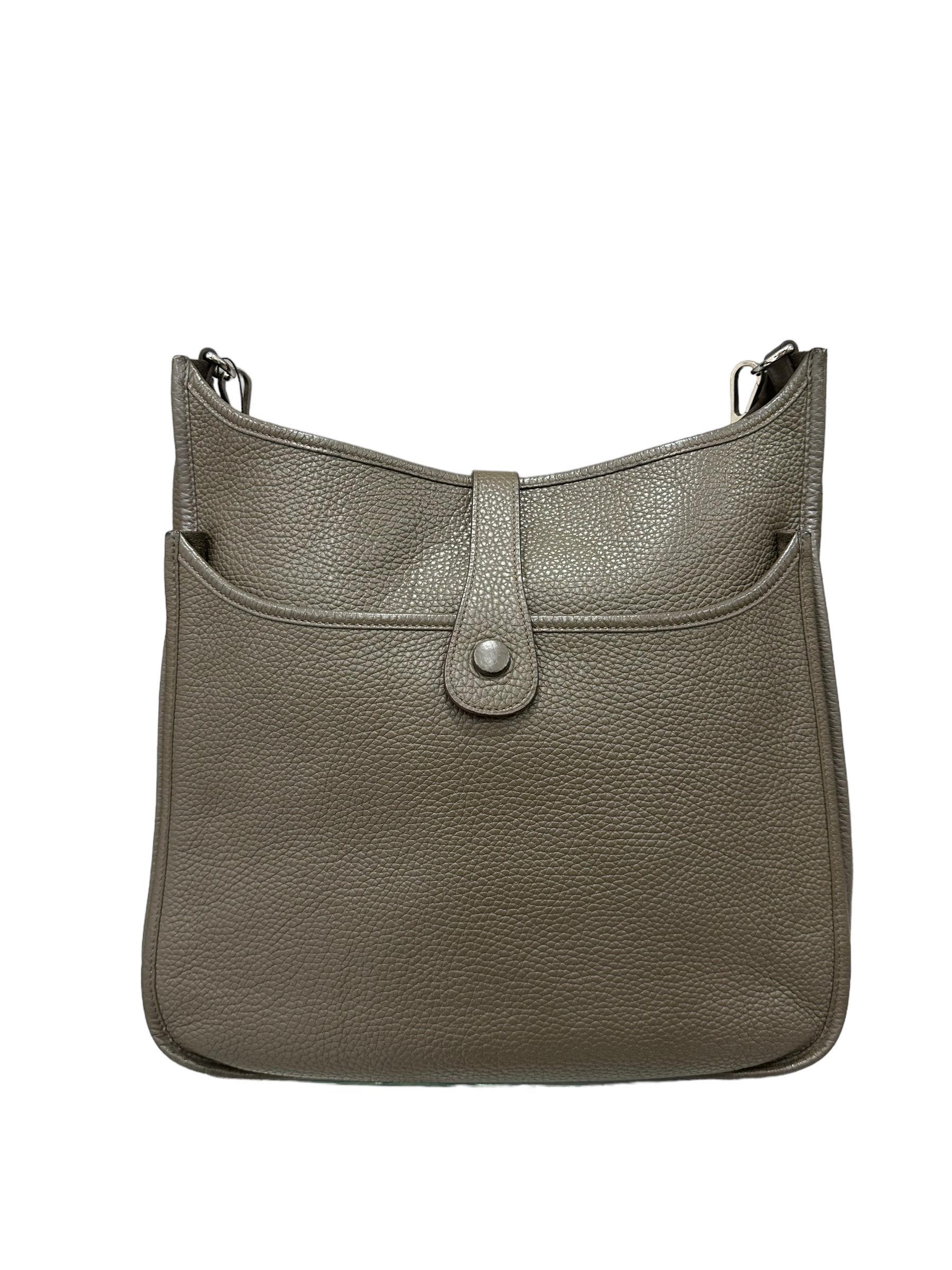 Bag signed Hermès, model Evelyne, size GM, made in soft-touch Ecorce clemence leather. Equipped with a central closure with a button band, internally lined in suede, very roomy. Equipped with a removable and adjustable shoulder strap in fabric, and
