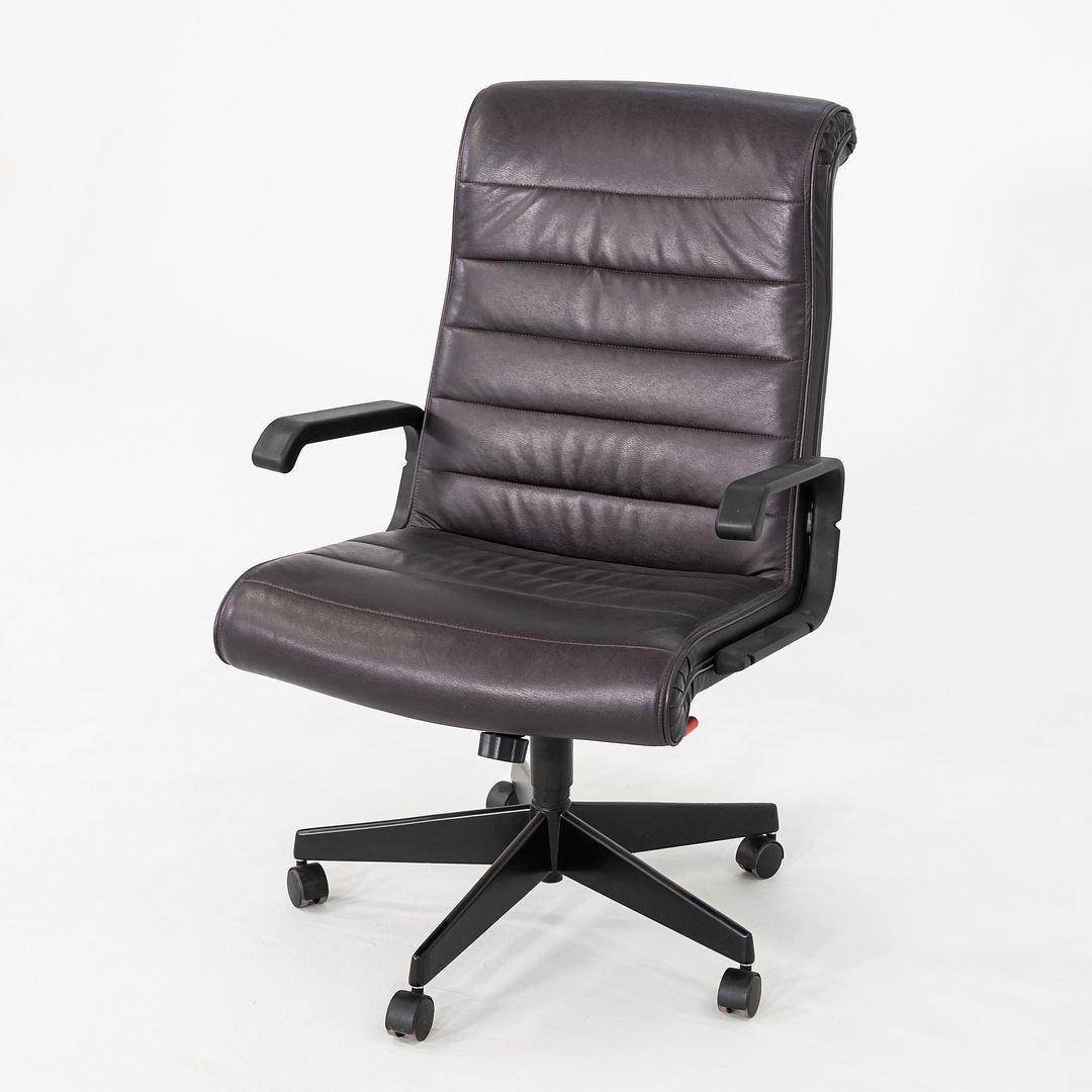 This is a Sapper Executive Desk chair, originally designed by Richard Sapper for Knoll in 1979. This example dates to 2003. The piece is comprised of a steel base with a pneumatic adjustable mechanism, and a seat upholstered in dark purple