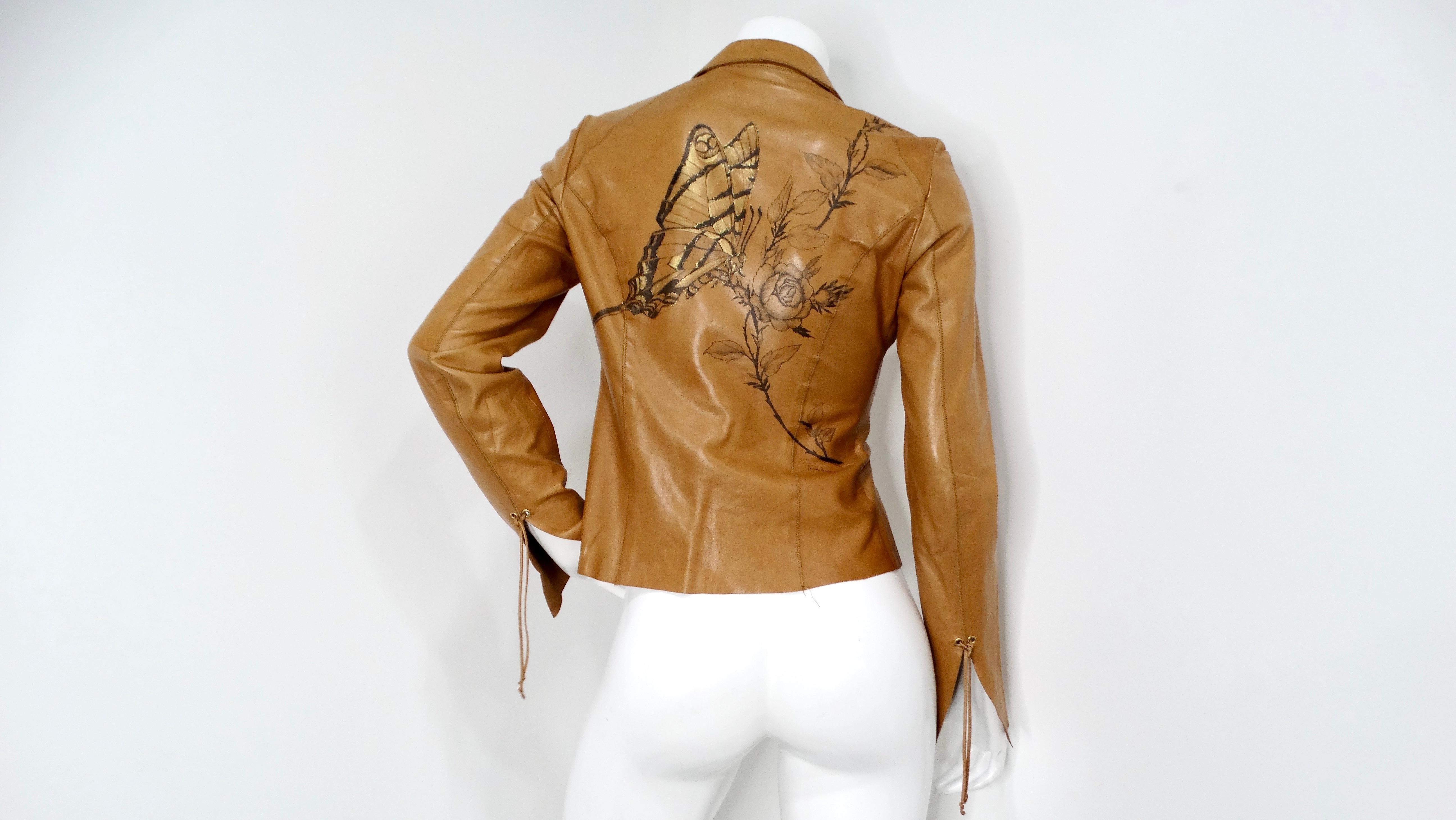 Introducing the exquisite 2003 Roberto Cavalli Brown Leather Jacket, a stunning piece that combines luxurious materials with artistic flair. This warm brown leather jacket is meticulously crafted to feature a unique clasp-down front, offering an