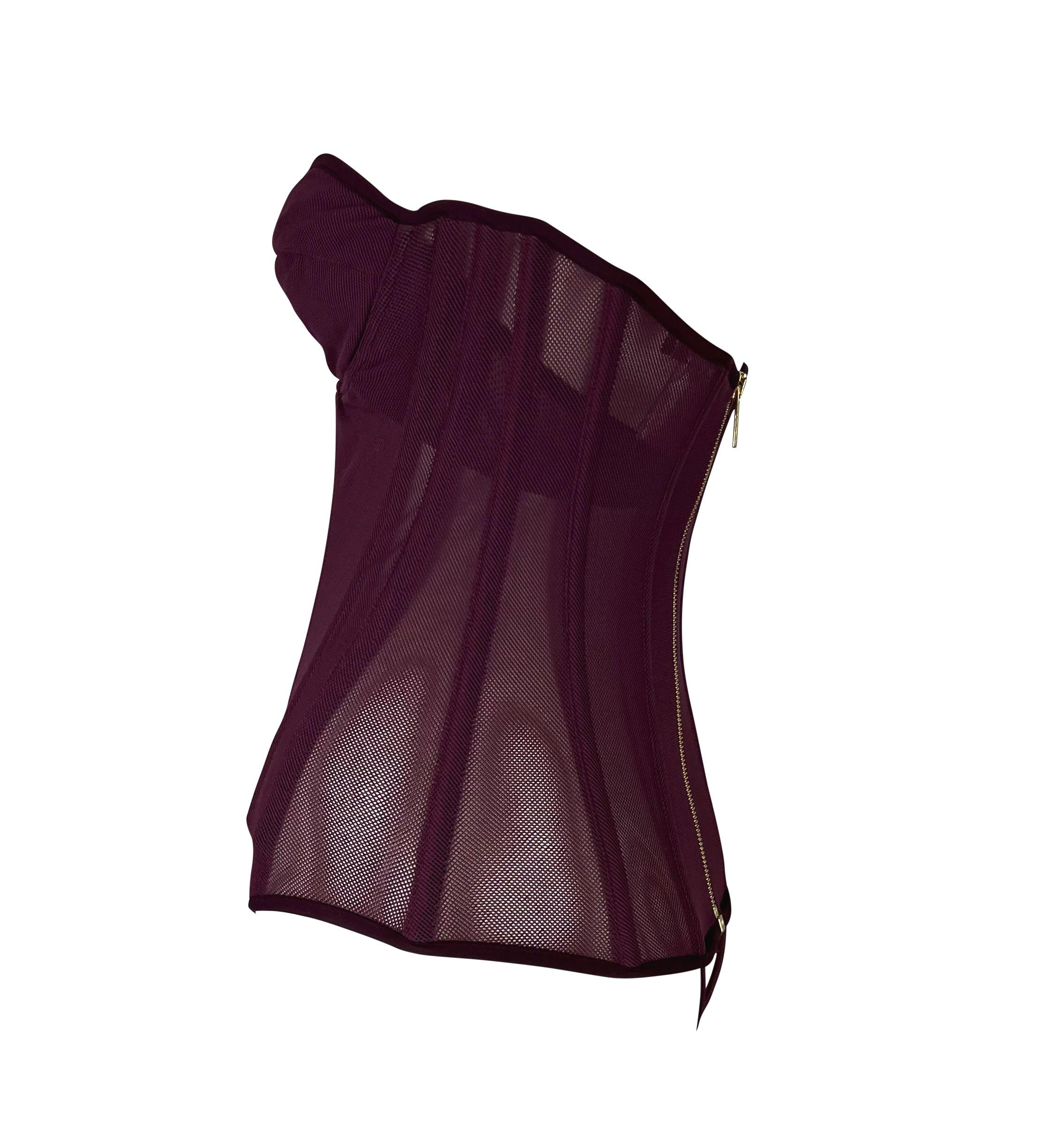 TheRealList presents: a burgundy mesh Roberto Cavalli body suit. From 2003, this fabulous strapless body suit is constructed of see-through mesh and outfitted with boning to create a corsetted form-fitting look. This top is made complete with an