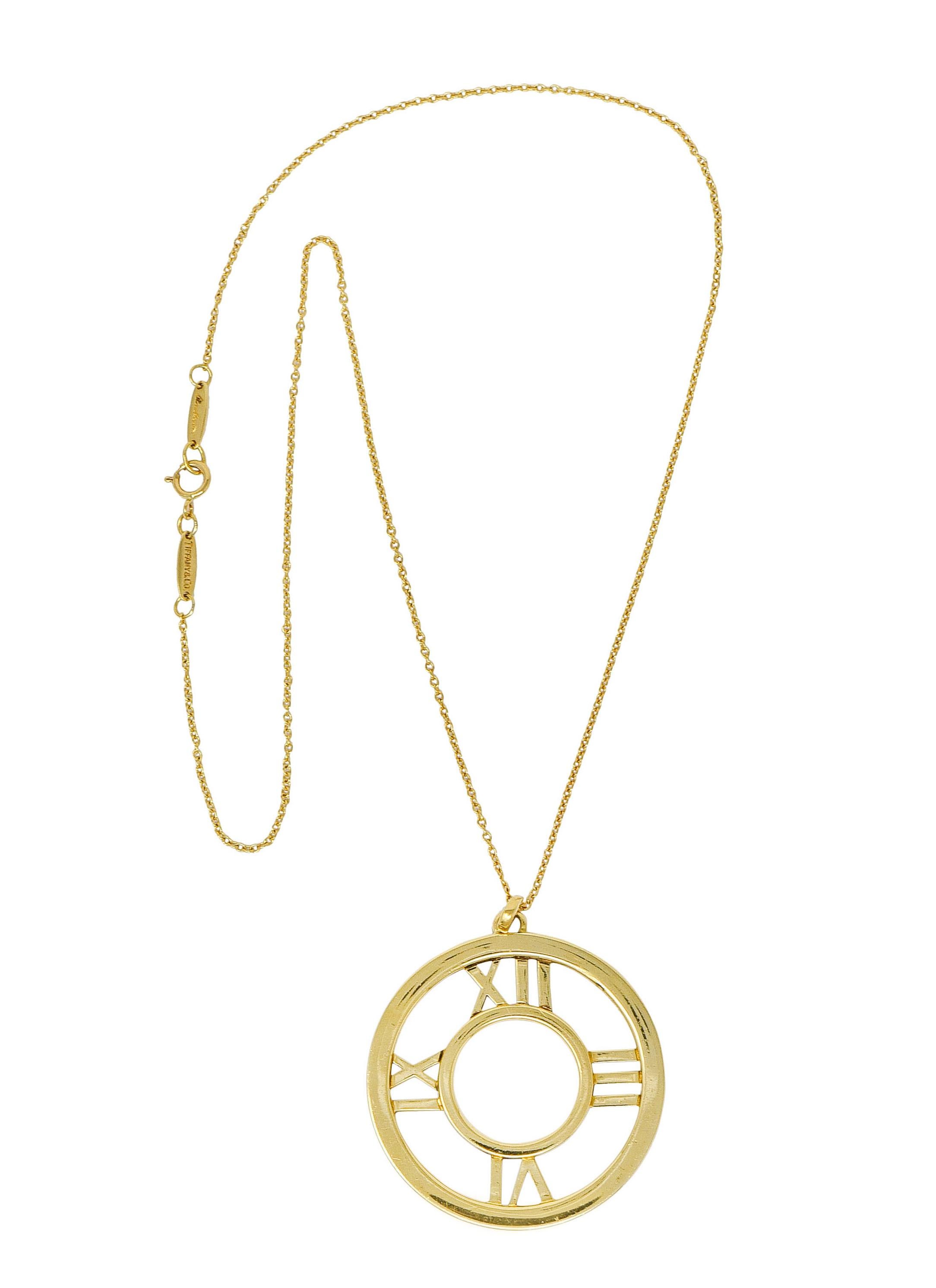 Designed as a pierced pendant with two concentric polished gold circles

Accented by polished gold Roman numerals at each cardinal point

Accompanied by cable chain fully signed Tiffany & Co. Elsa Peretti Spain; completed by spring ring
