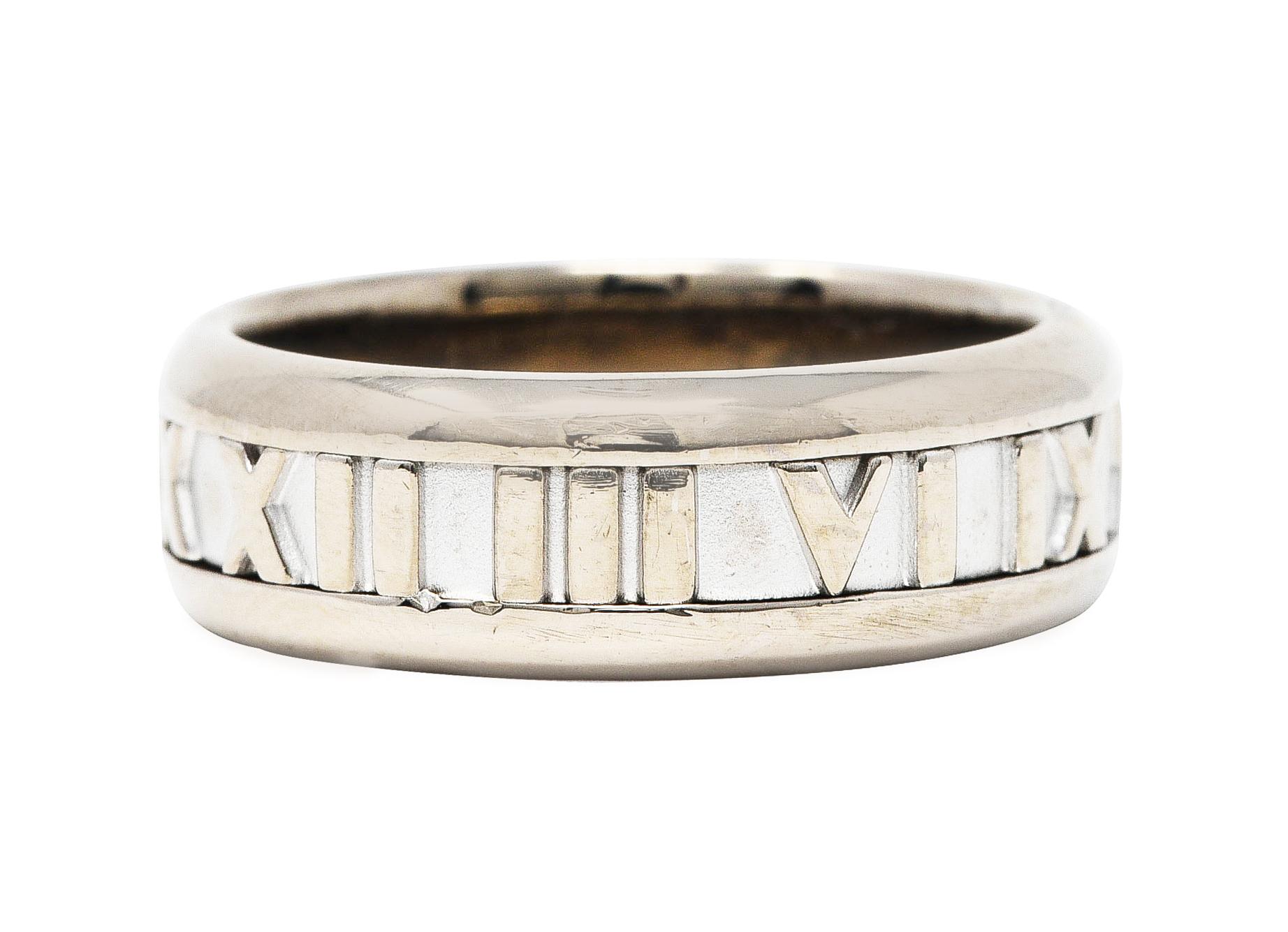 Band style ring designed with row of grooved Roman numerals fully around

Featuring high polished numbers and edges

Stamped 750 for 18 karat white gold

Fully signed 2003 Tiffany & Co. from the Atlas collection

Ring size: 7 3/4 and not