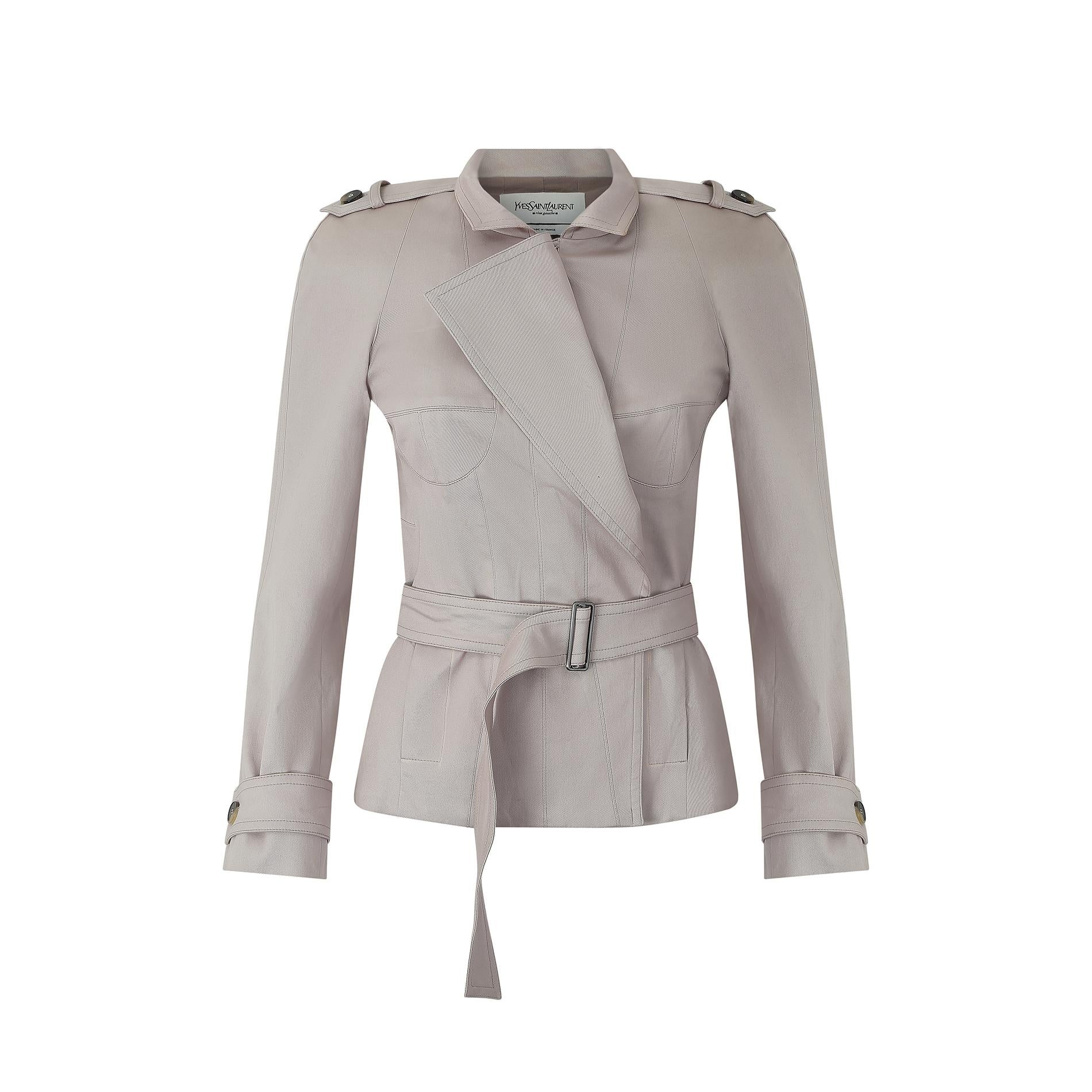 This spring / summer 2003 collection belted trench style jacket was designed by Tom Ford for Yves Saint Laurent during his tenure as creative director between 1999 and 2004. It is crafted from a thick, high-quality oyster pink coloured cotton blend,