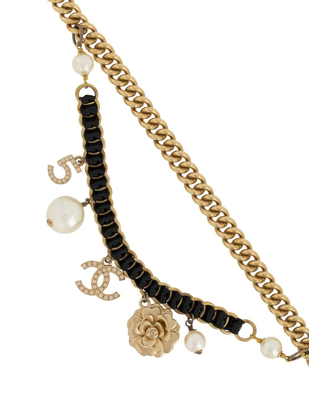 Chanel necklace featuring charms, faux ivory pearl beads, logo charms, gold-plated hardware, and a logo back plaque.  Could be worn as a belt too.
In excellent vintage condition  Made in France. 
Circa 2003s
Length When Open 35.4in. (90cm)
We