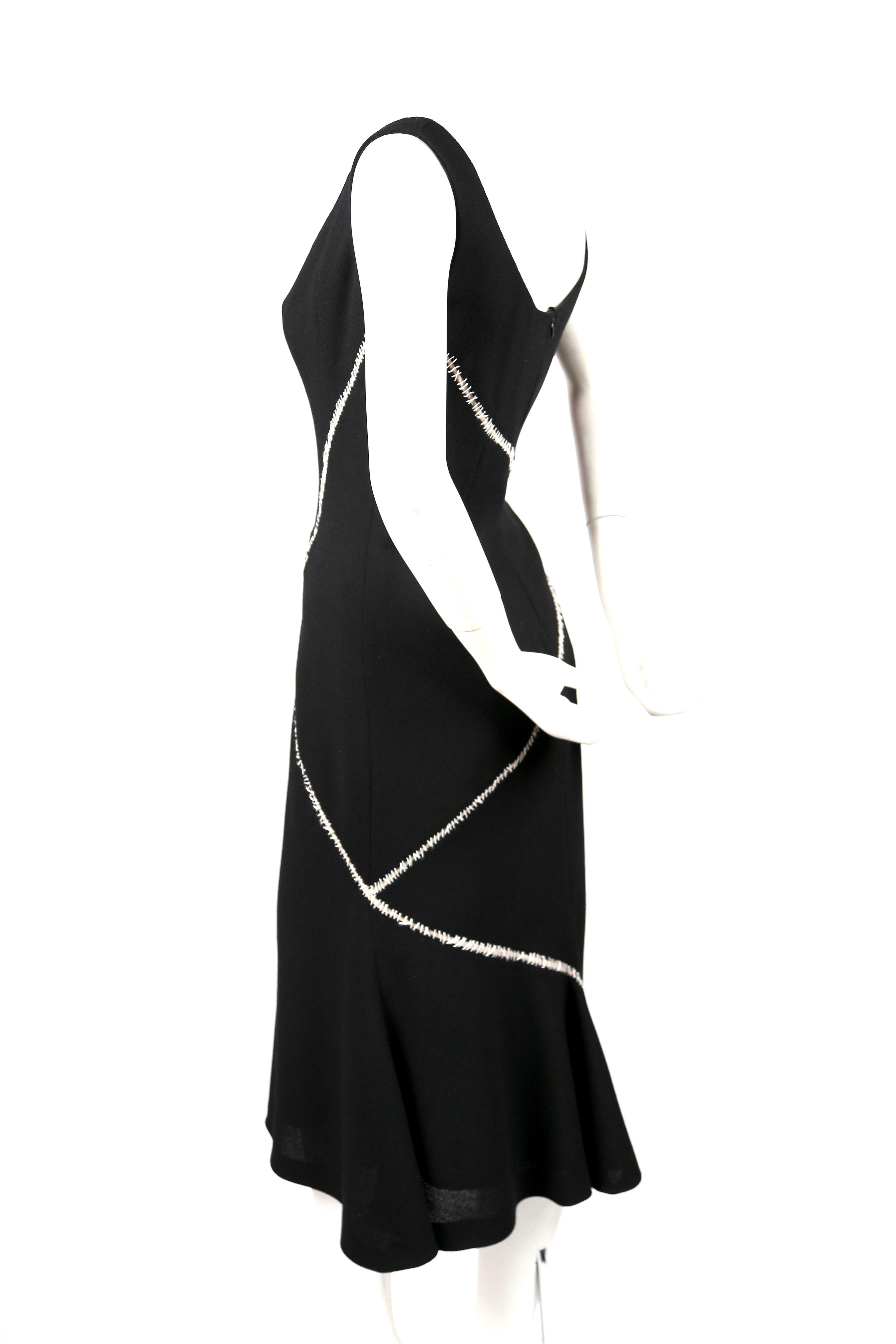 Black wool and silk crepe dress with decorative white stitched detail designed by Alexander McQueen circa 2004. Labeled an Italian size 42. Measures approximately: 34