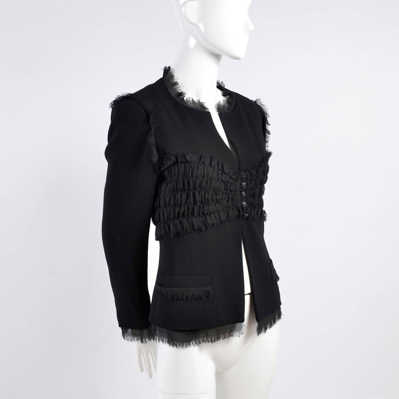 This new black wool & silk Chanel jacket has gorgeous ruching and pretty fabric fringe.  The jacket is from Chanel's 04 Spring collection and has black CC logo crystal embellished buttons, front pockets, the signature Chanel chain at hem and it is