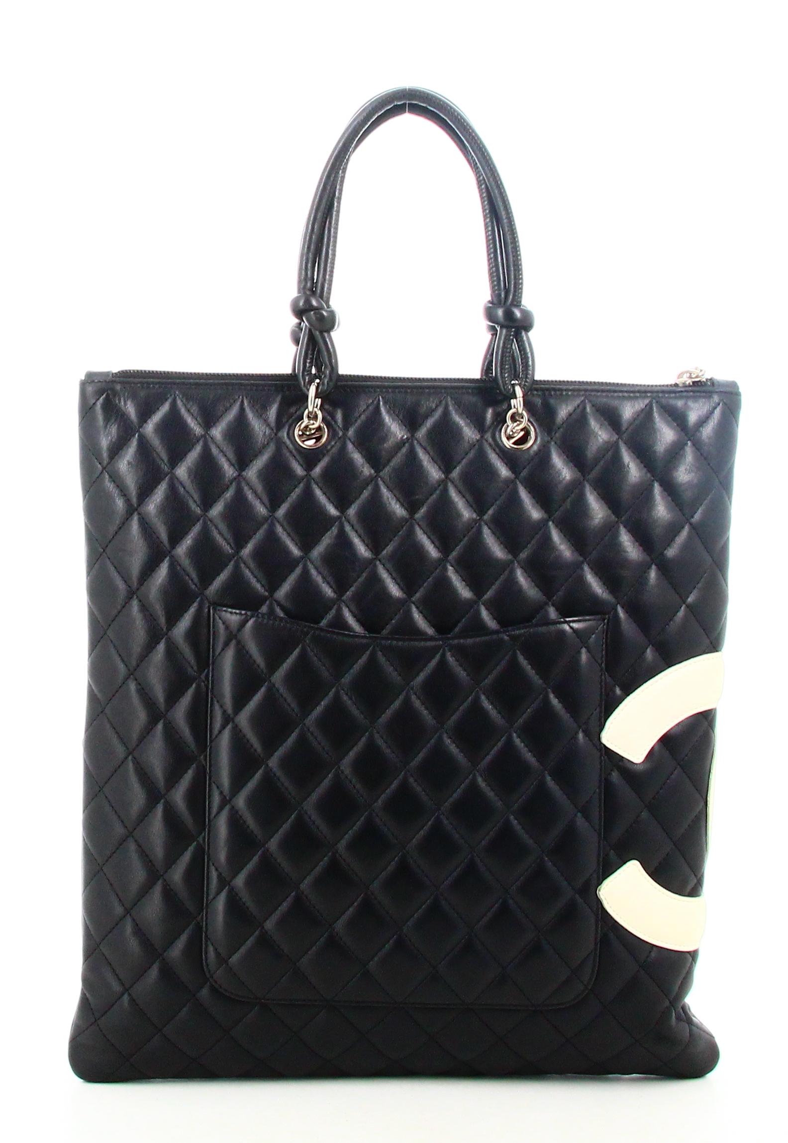 2004 Chanel Cambon Bag Flat Tote Line

- Very good condition. shows slight signs of wear over time. 
- Chanel handbag
- black quilted leather
- double C on the side 
- two black leather straps 
- clasp: zip 
- inside: pink monogram lining plus