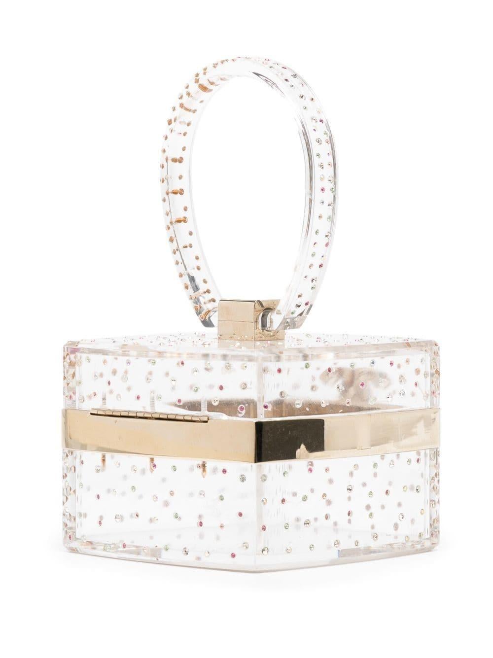 This rare and collectible CC rhinestone-embellished vanity mini bag from Chanel 2004 features a clear body with rhinestone embellishments and gold-tone hardware. Its signature interlocking CC logo sculpted on the front evokes Maison's founder, Coco