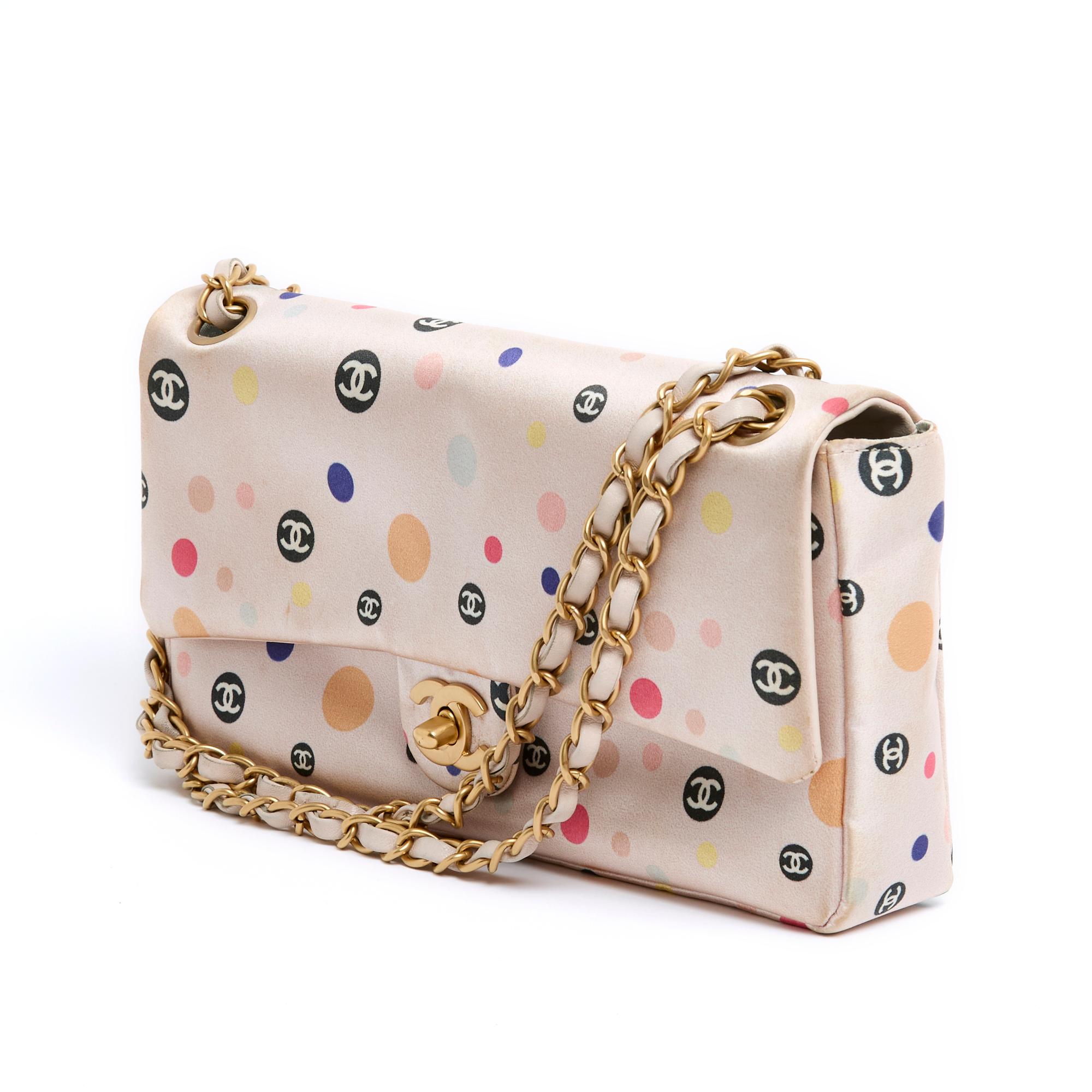 Chanel Timeless or Classic Series single flap bag in pink silk satin printed with multicolored polka dots, the black polka dots being signed with the CC logo, flap closure with quarter-turn clasp in matte gold metal, interior in light blue canvas