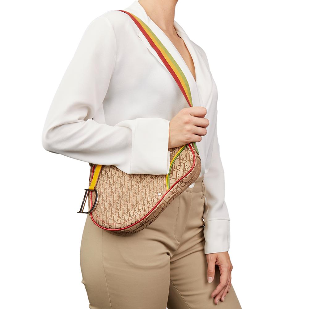 CHRISTIAN DIOR
Brown Monogram Canvas Rasta Saddle Bag

Xupes Reference: HB2102
Serial Number: 08RU 0054
Age (Circa): 2004
Authenticity Details: Date Stamp (Made in Italy) 
Gender: Ladies
Type: Shoulder, Crossbody

Colour: Brown
Hardware: