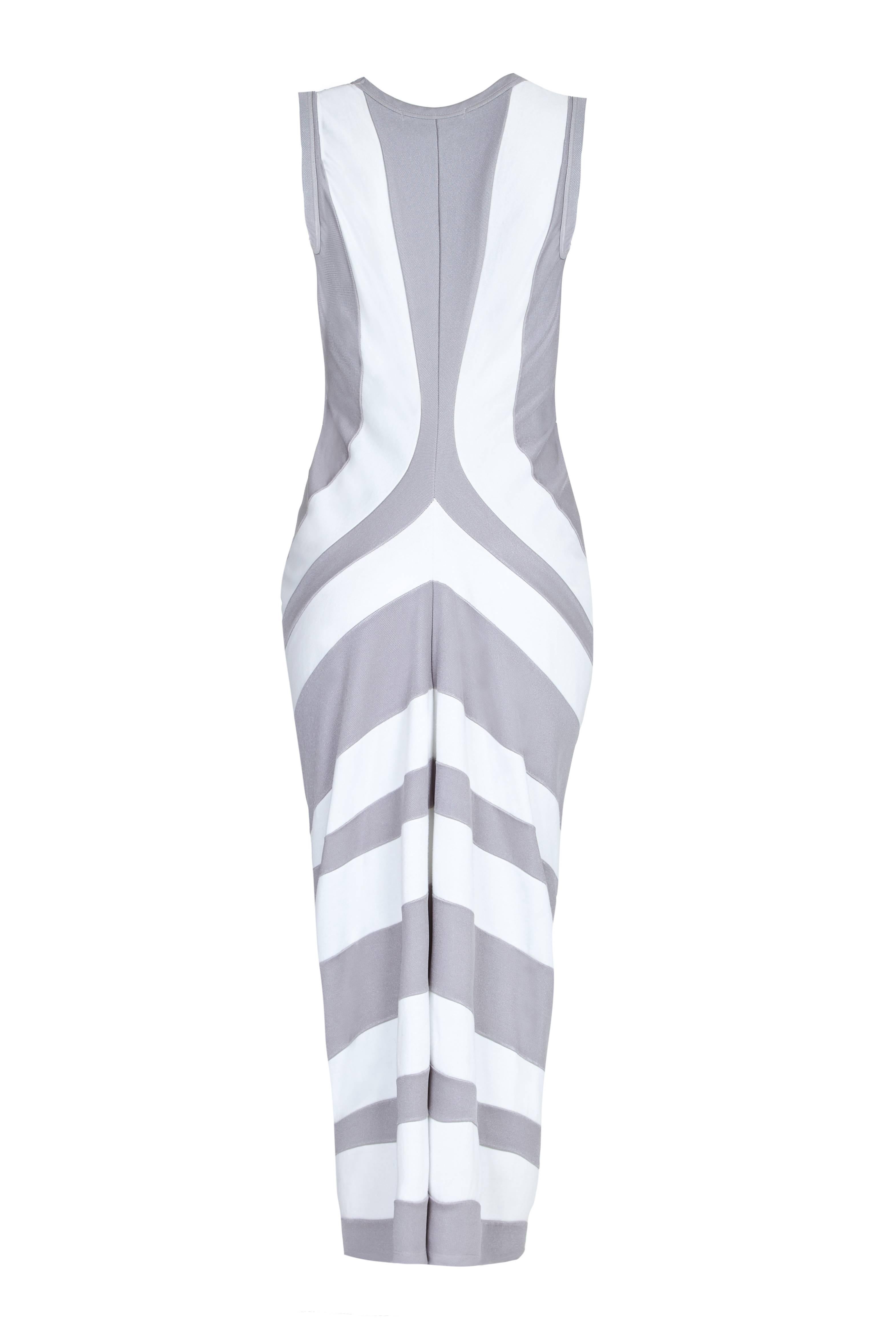 This sensational 2004 striped draped jersey dress is by iconic Japanese label Come Des Garçons and is a beautiful example of the brand's avant garde use of unusual and complex cutting. The cotton/ polyester jersey fabrics are arranged into broad