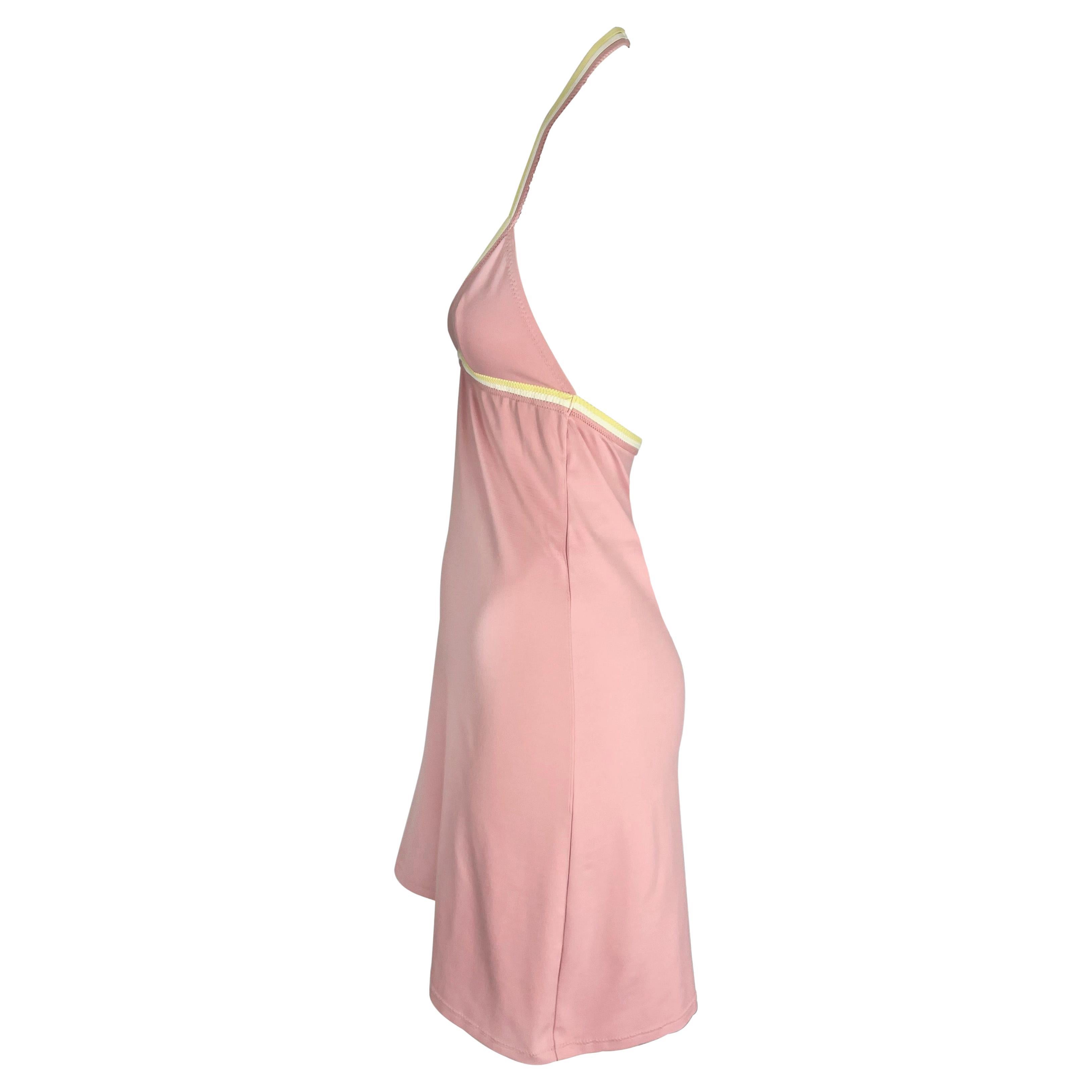 Presenting a fabulous light pink Chanel halter neck mini dress, designed by Karl Lagerfeld. From the 2004 Cruise collection, this flared dress is constructed of an elastic material that allows this dress to perfectly hug the body. The dress features