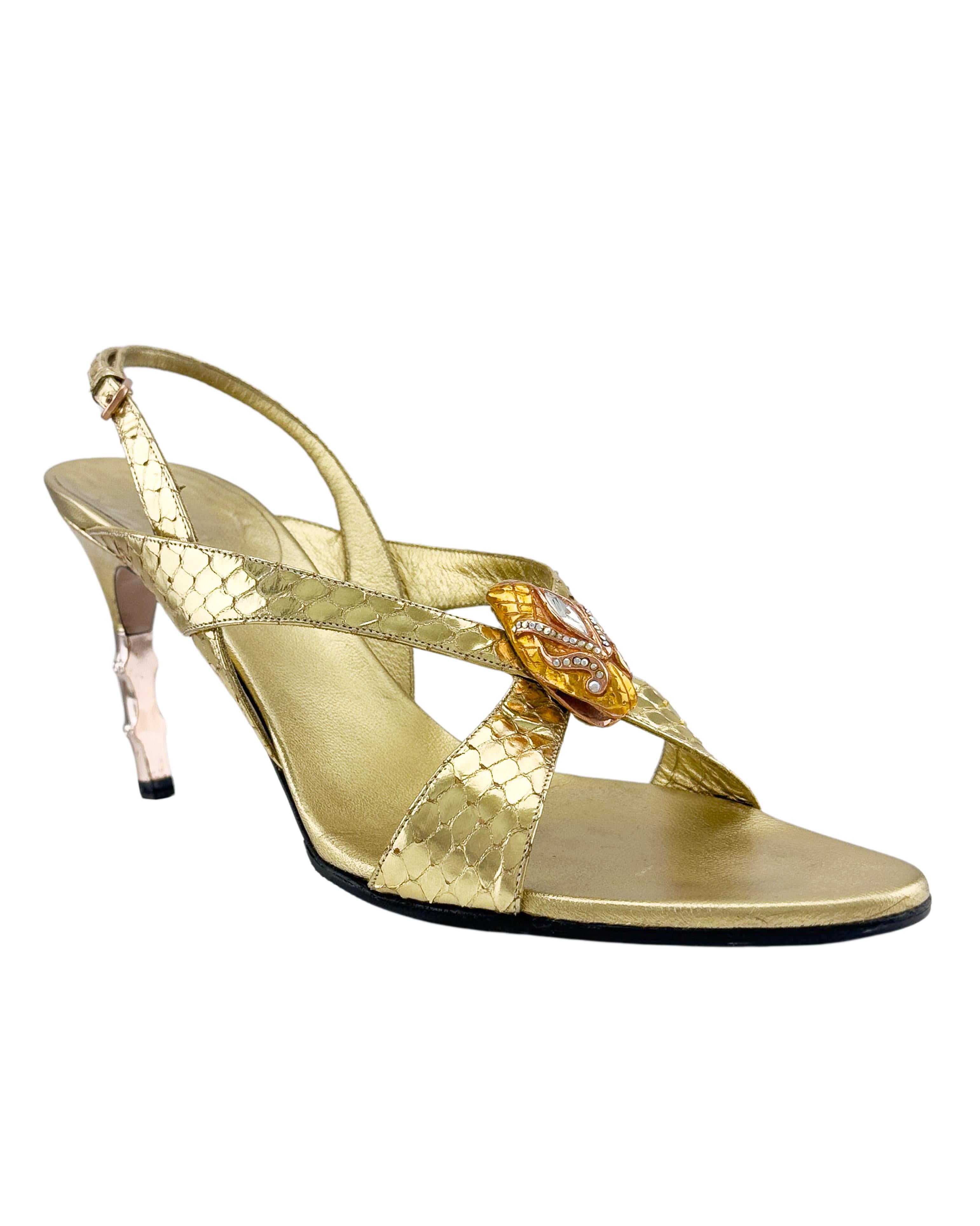 Strappy metallic gold snake print open toe sandals from Tom Ford's iconic and highly sought after run at the helm of Gucci. These sandals are sexy and fun. Embellished with a gold tone metal and rhinestone encrusted snake head at the toe and a 2