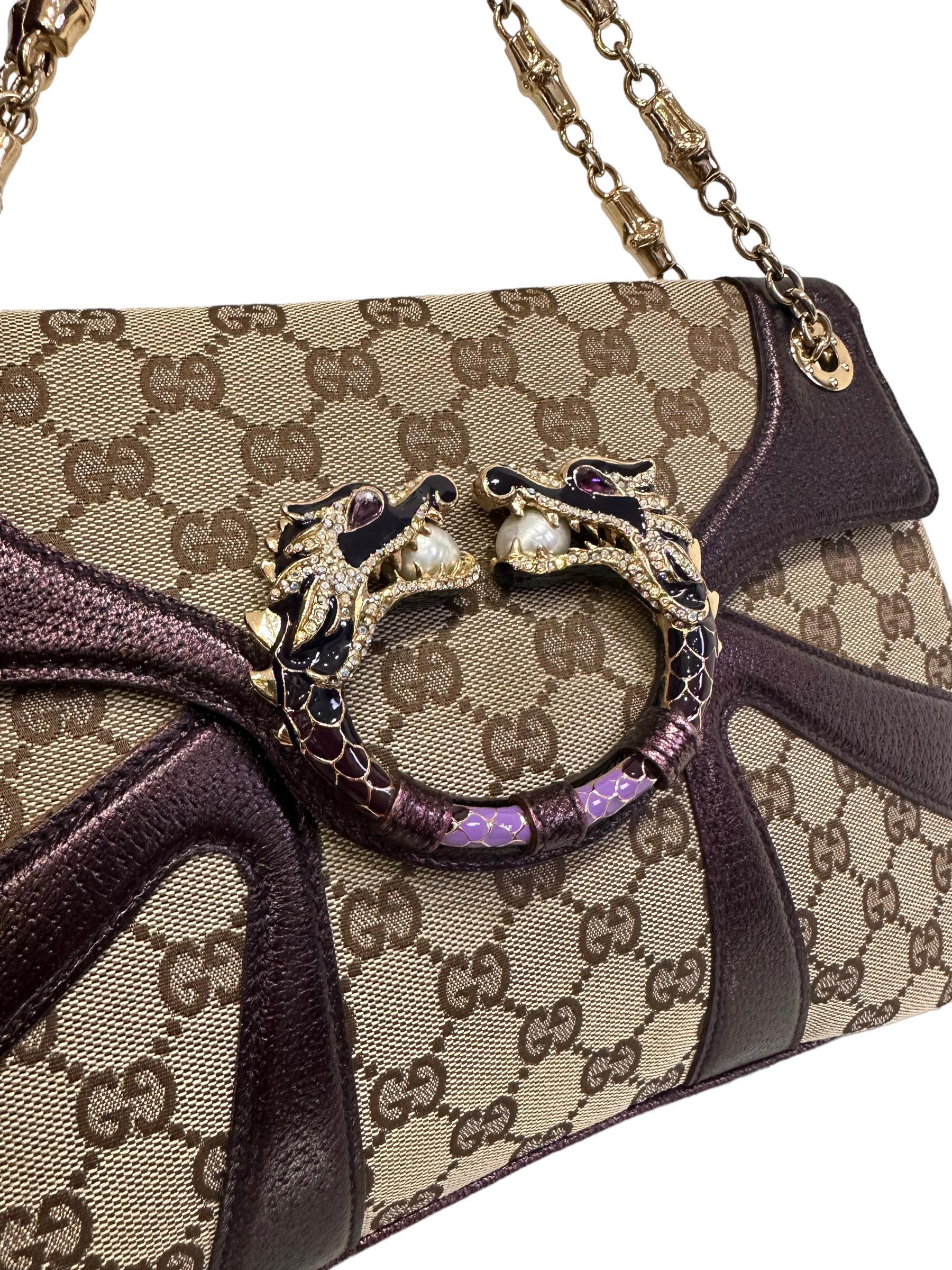 Gucci bag, Dragon model, limited edition Tom Ford line, 2004 collection, made in GG Supreme canvas with purple leather inserts and golden hardware. The bag has a front flap with button closure, internally lined in brown canvas, quite large. Equipped