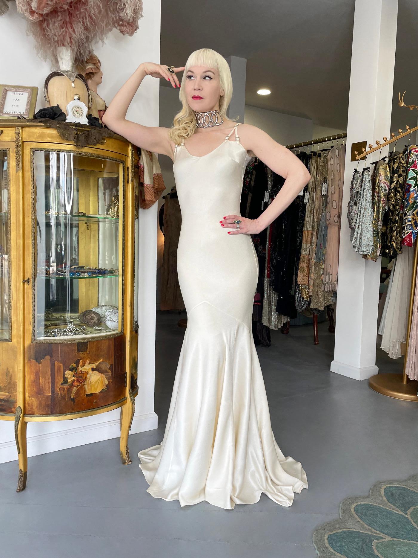 A highly coveted and totally ethereal John Galliano ivory satin back crepe bias-cut gown from John Galliano's celebrated 2004 spring-summer collection. As shown, the same dress was worn by Kim Kardashian for the 'Times 100