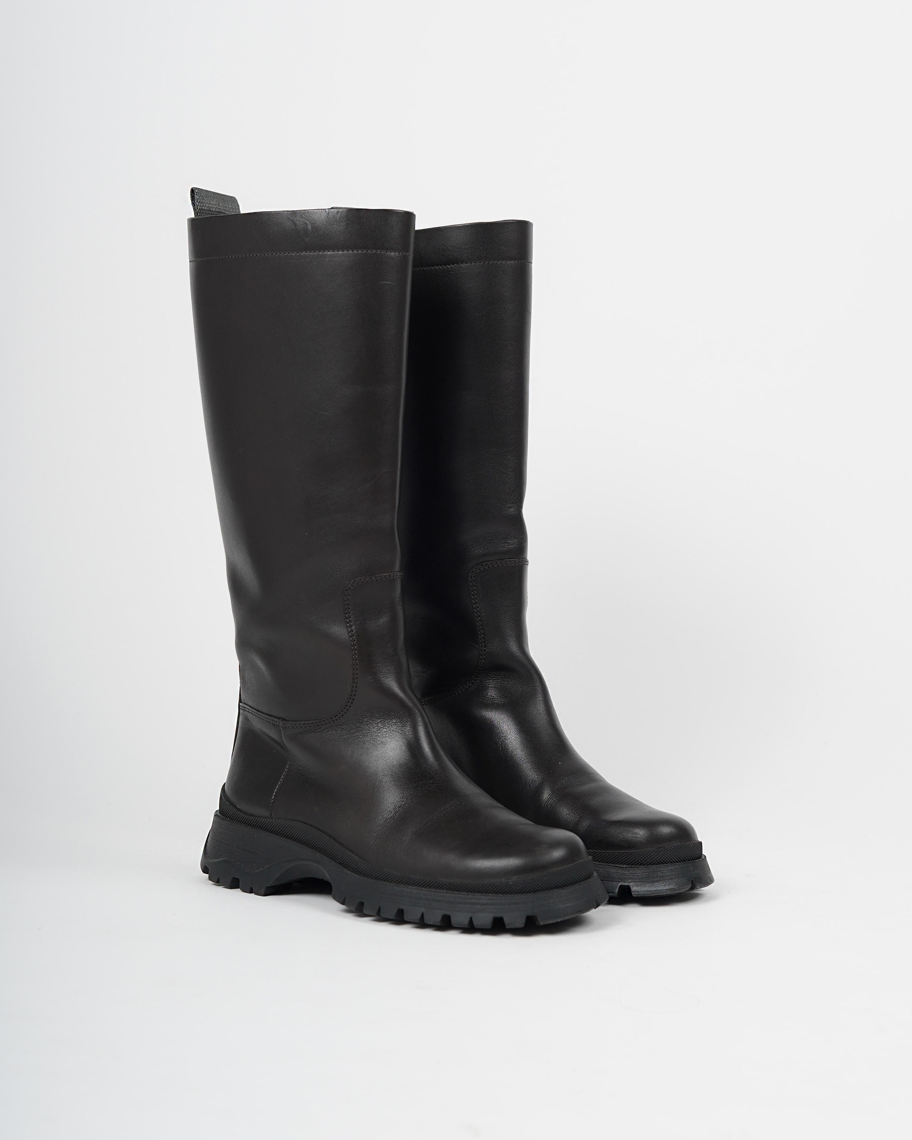 Presenting a pair of rare 2004 Prada Sport ebony Napa leather lug-sole boots most famously worn by Bella Hadid on more than one occasion. The combat boots in question are knee-high, made of dark brown calfskin Napa leather and come with a durable
