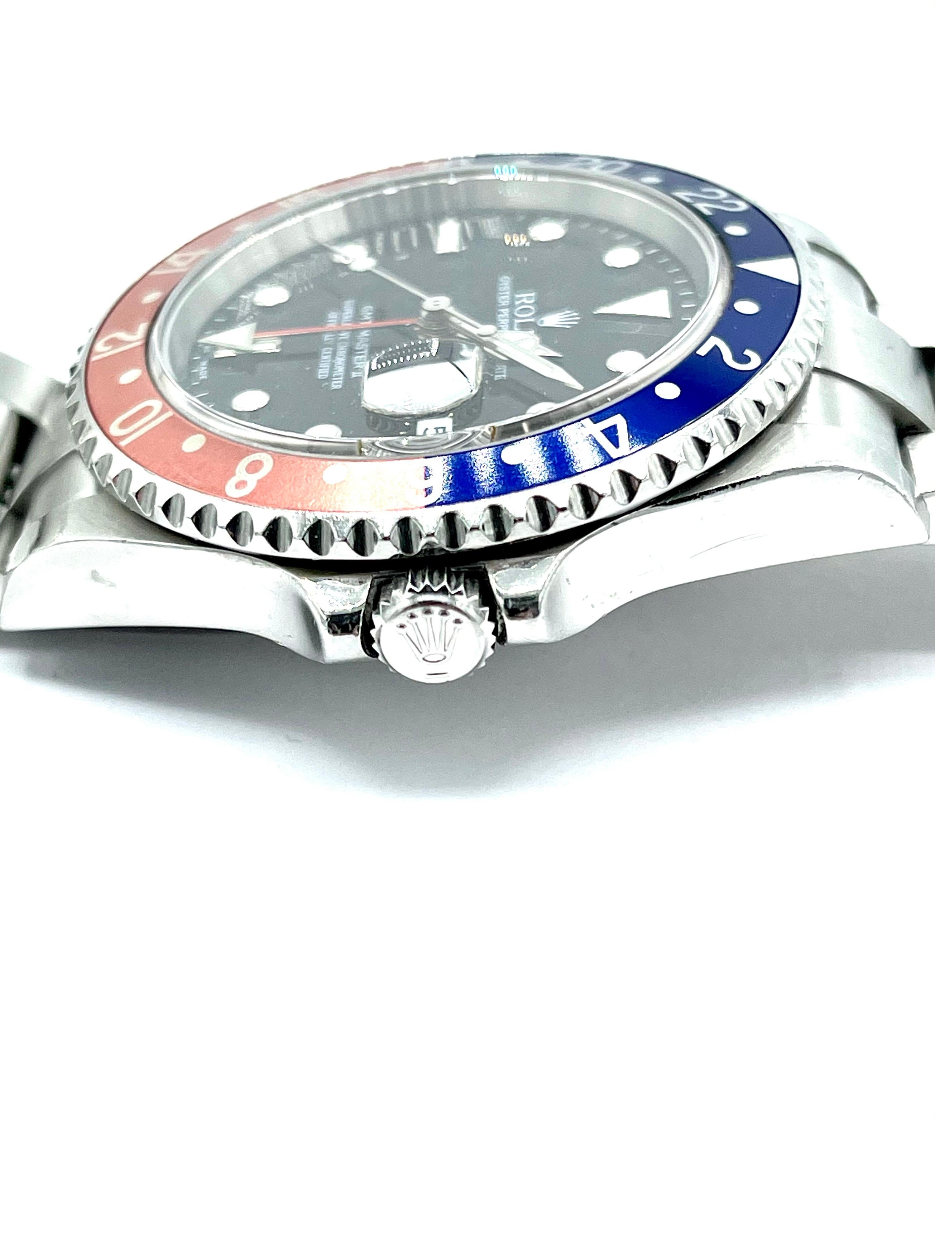 A rare find!  2004 Rolex GMT Master II Pepsi edition stainless steel watch.  The watch is a 40mm case with a black dial and sapphire crystal, and the Rolex signature magnification over the date.  Style number 16710T, serial number F679398.  The