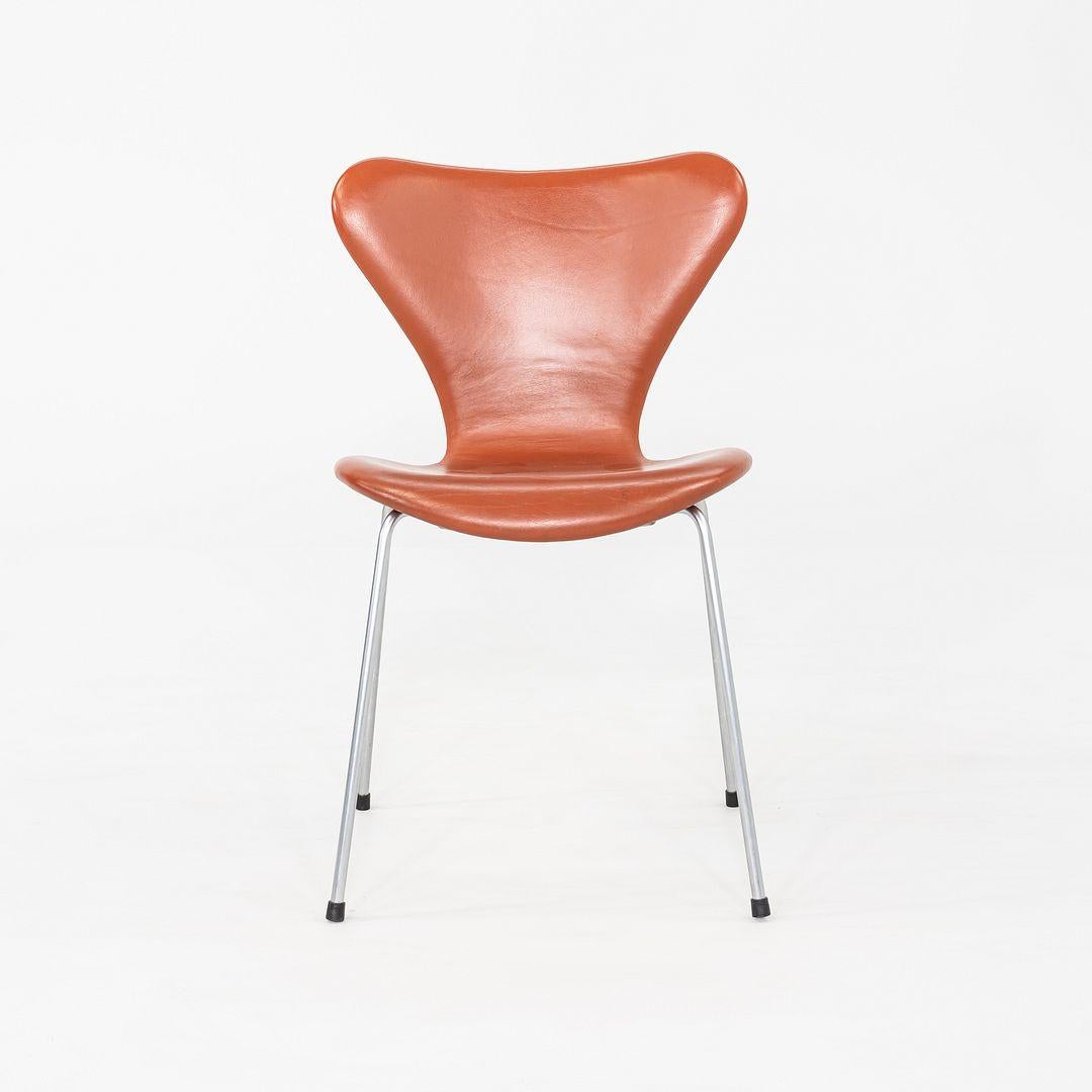 This is a set of four Series 7 Dining Chairs, Model 3107, originally designed by Arne Jacobsen for Fritz Hansen in 1955. These examples were produced in Denmark and date to 2004. The design features a tubular steel frame with a chrome-plated finish,