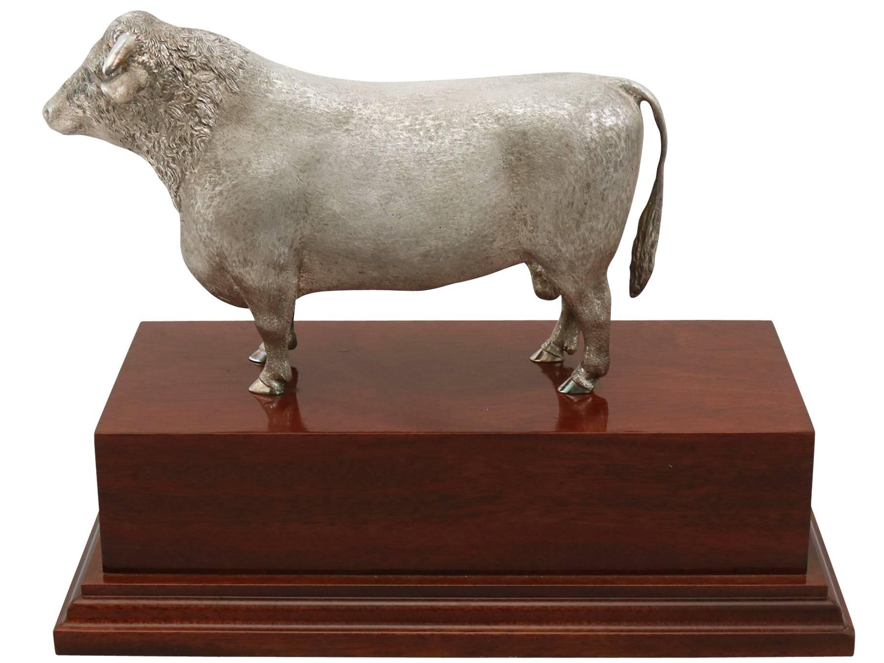 An exceptional, fine and impressive contemporary Elizabeth II English cast sterling silver presentation bull on mahogany plinth; an addition to our animal related silverware collection.

This exceptional contemporary English cast sterling silver