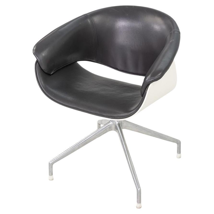 This is a Sina swivel arm chair by B&B Italia. The chair was designed by Uwe Fischer and introduced in 1999. These particular examples date to 2004. They are upholstered in high quality black leather and have polished aluminum bases. The price