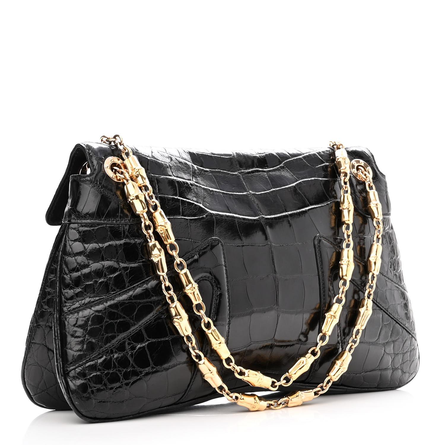2004 Vintage Tom Ford for GUCCI Black Alligator Bag with Crystal Embellishment
The bag features gold bamboo shaped chains, a frontal flap and a double headed jeweled dragon clasp. 
Opens to a black smooth leather interior with a patch