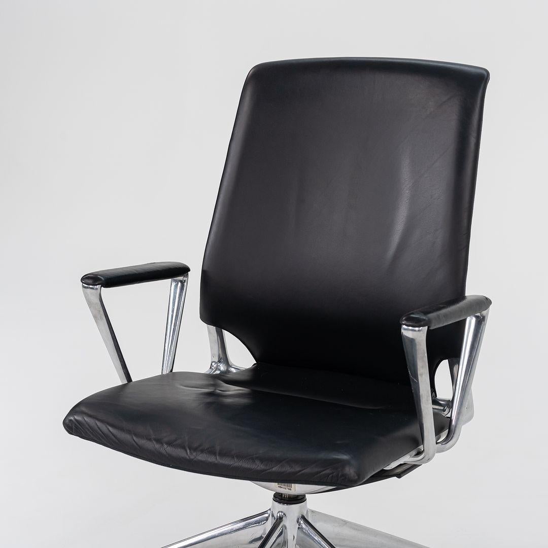 This is a Vitra Meda desk chair, originally designed by Alberto Meda in 1996. This particular example was produced by Vitra in Germany C. 2004. The design is comprised of an aluminum base with a seat upholstered in black leather and fabric on the