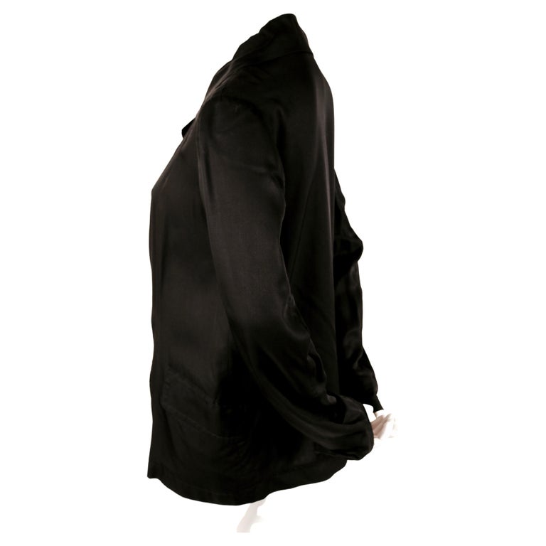 Jet-black jacket with large silver grommets from Yohji Yamamoto exactly as seen on the runway for spring of 2004 . Labeled a Japanese size '1' which fits a US small or possibly a medium. Approximate measurements: shoulders 16