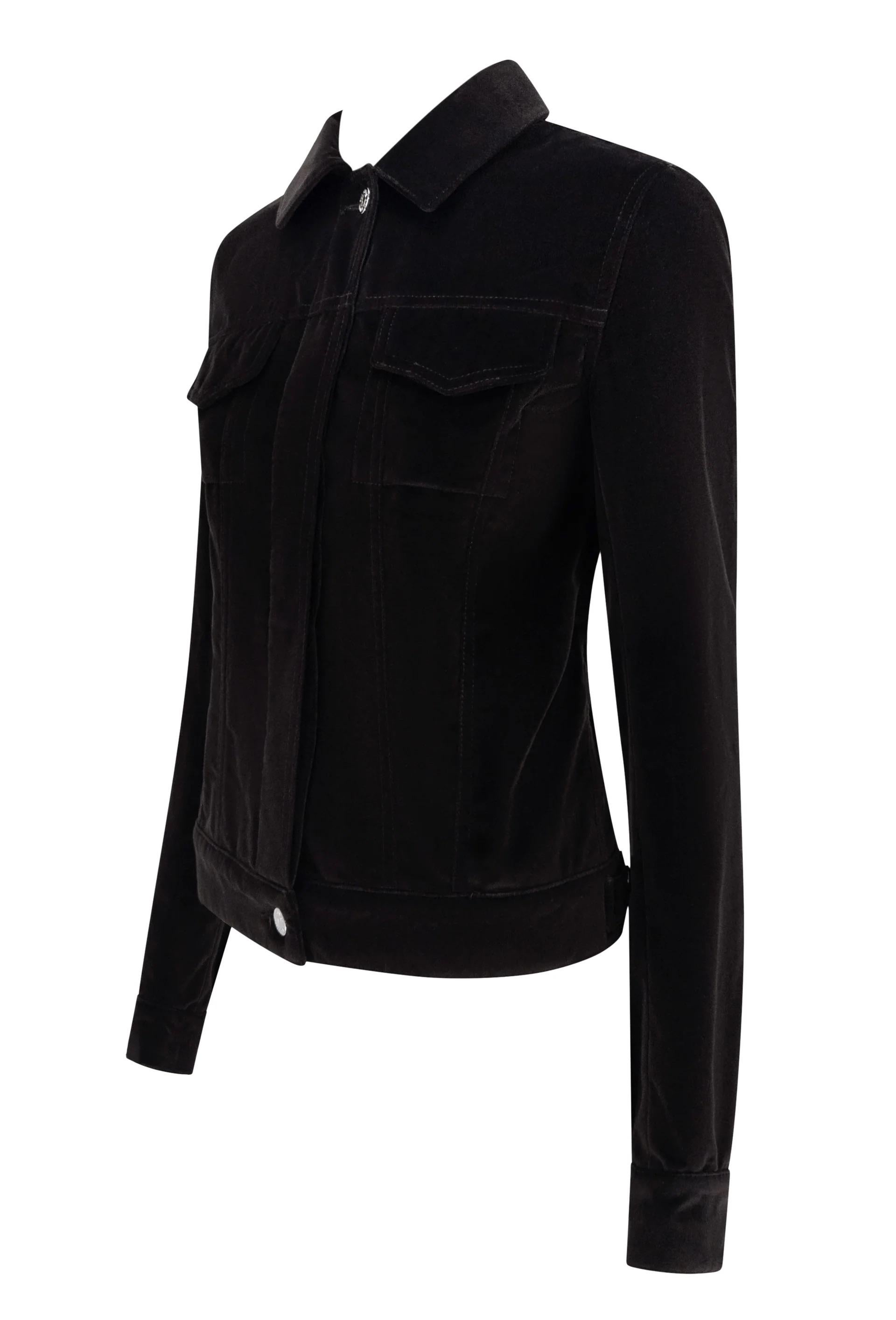 Questa giacca Yves Saint Laurent del 2004 di Tom Ford è realizzata in ricco velluto marrone e ha un taglio sartoriale che reinterpreta la classica silhouette trucker. Presenta un colletto strutturato, tasche sul petto con patta e cuciture verticali