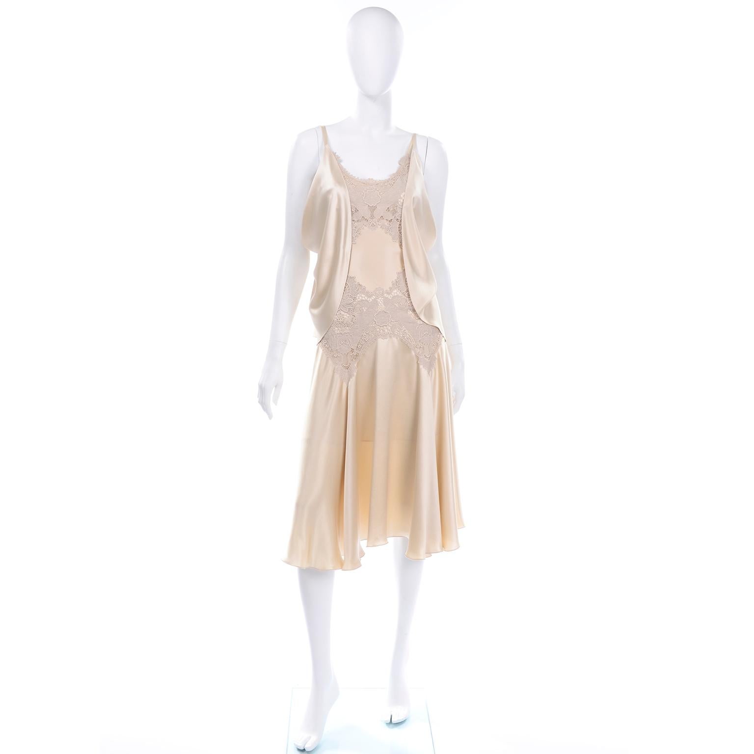 This is a stunning Alexander McQueen champagne silk dress with gorgeous nude lace trim on the bust and waist. This incredible dress has sheer panels on the bust and at the waist line. The waist has a panel of silk in between the lace, which