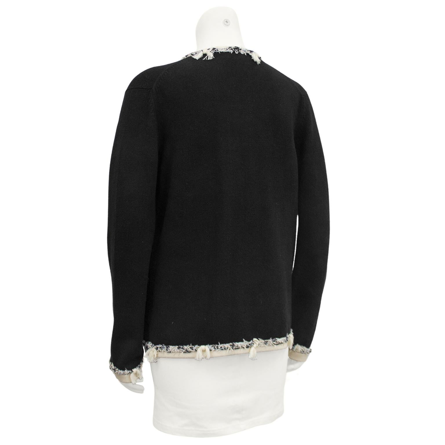 Chanel black 100% cashmere open front cardigan from 2005. Contrasting cream trim with black, white and cream deconstructed tweed fringe trim. Excellent vintage condition. Marked FR size 46, fits like a US size 8. Made in the United Kingdom. 