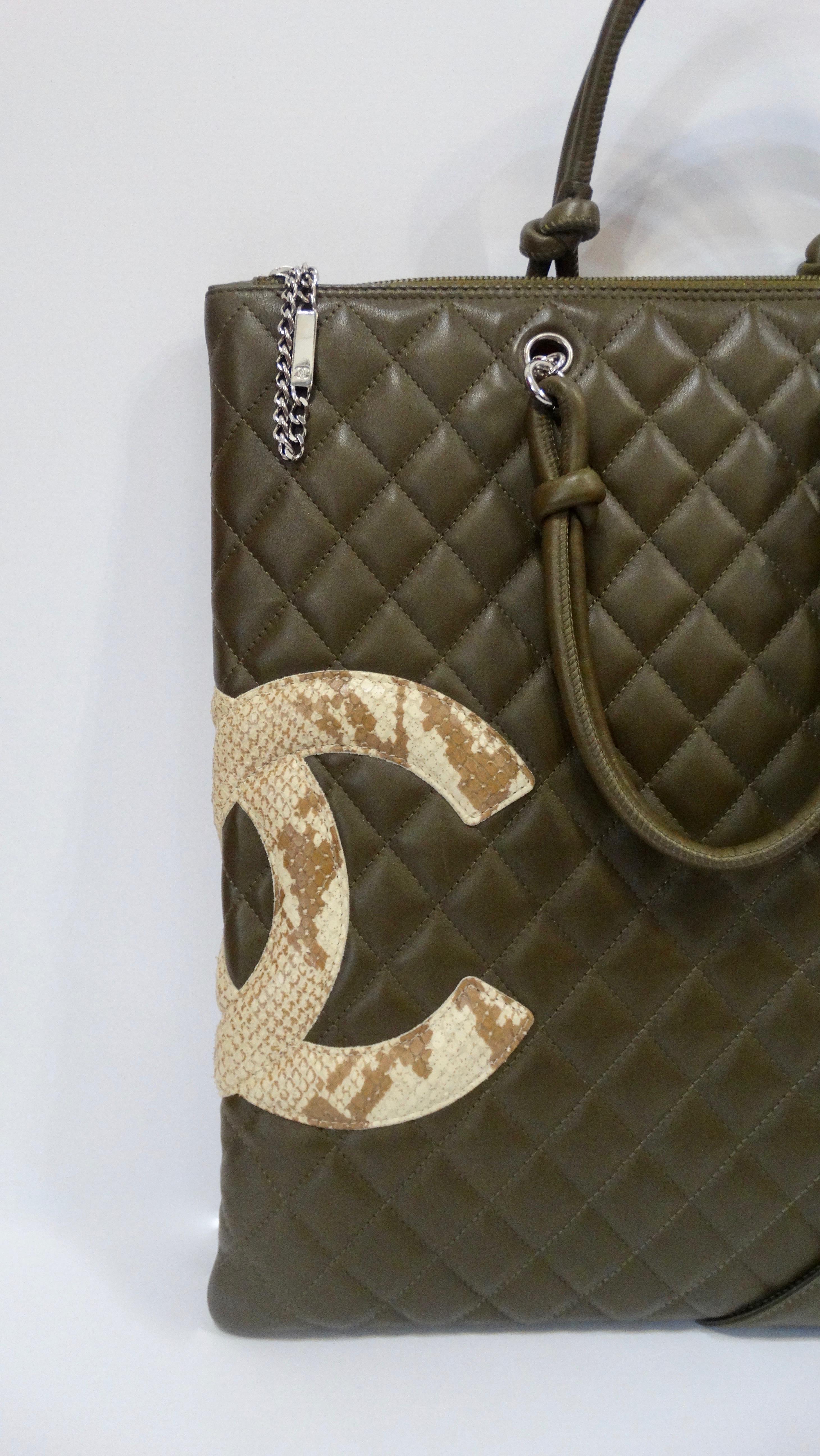 Carry around a piece of Karl Lagerfeld with this Chanel tote bag! Circa 2005, this Chanel Cambon tote bag is made of soft olive green lambskin leather and is stitched with Chanel's signature quilting pattern. Features dual knot rolled top handles,