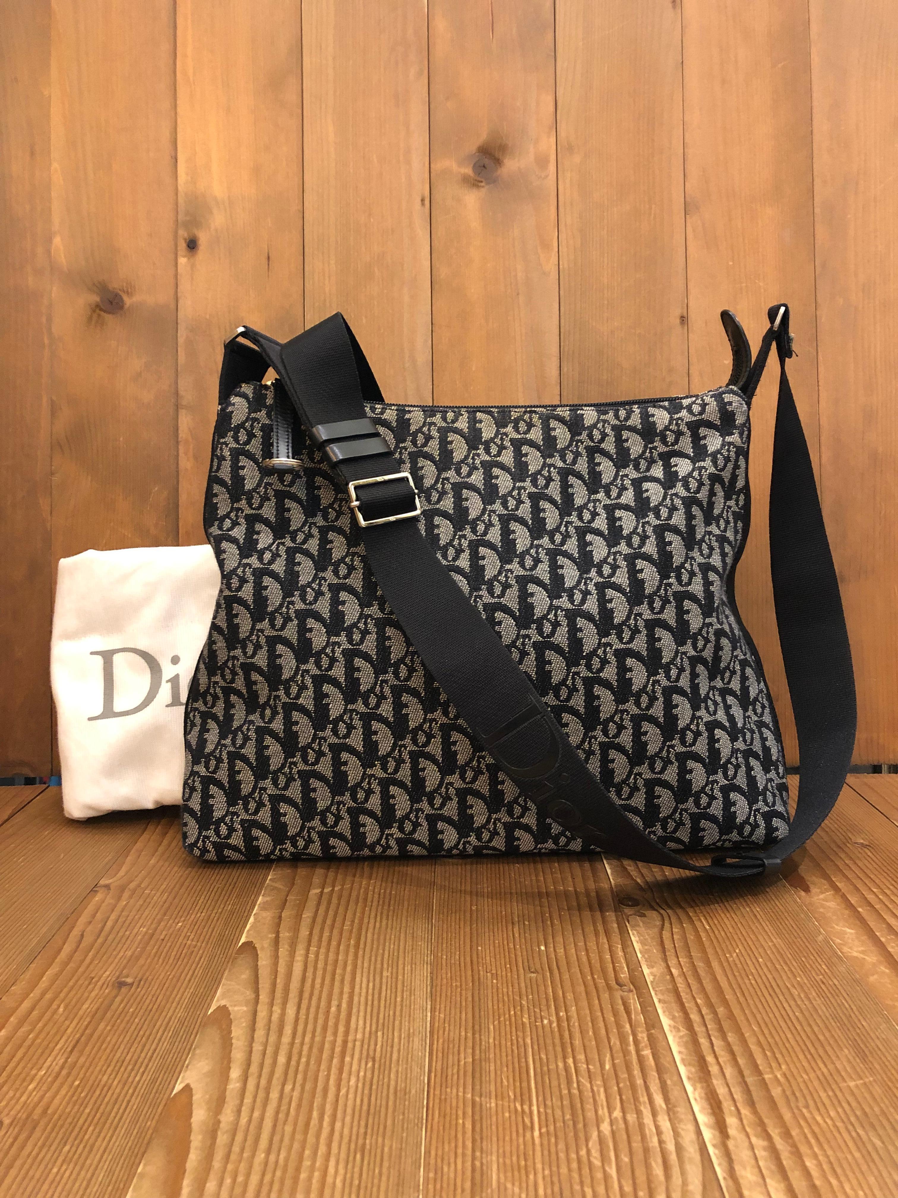 This stylish Christian Dior messenger crossbody bag is crafted of Dior’s trotter jacquard in black featuring silver toned hardware. Top zipper closure opens to spacious interior lined with black fabric featuring a zippered pocket. Made in Italy.