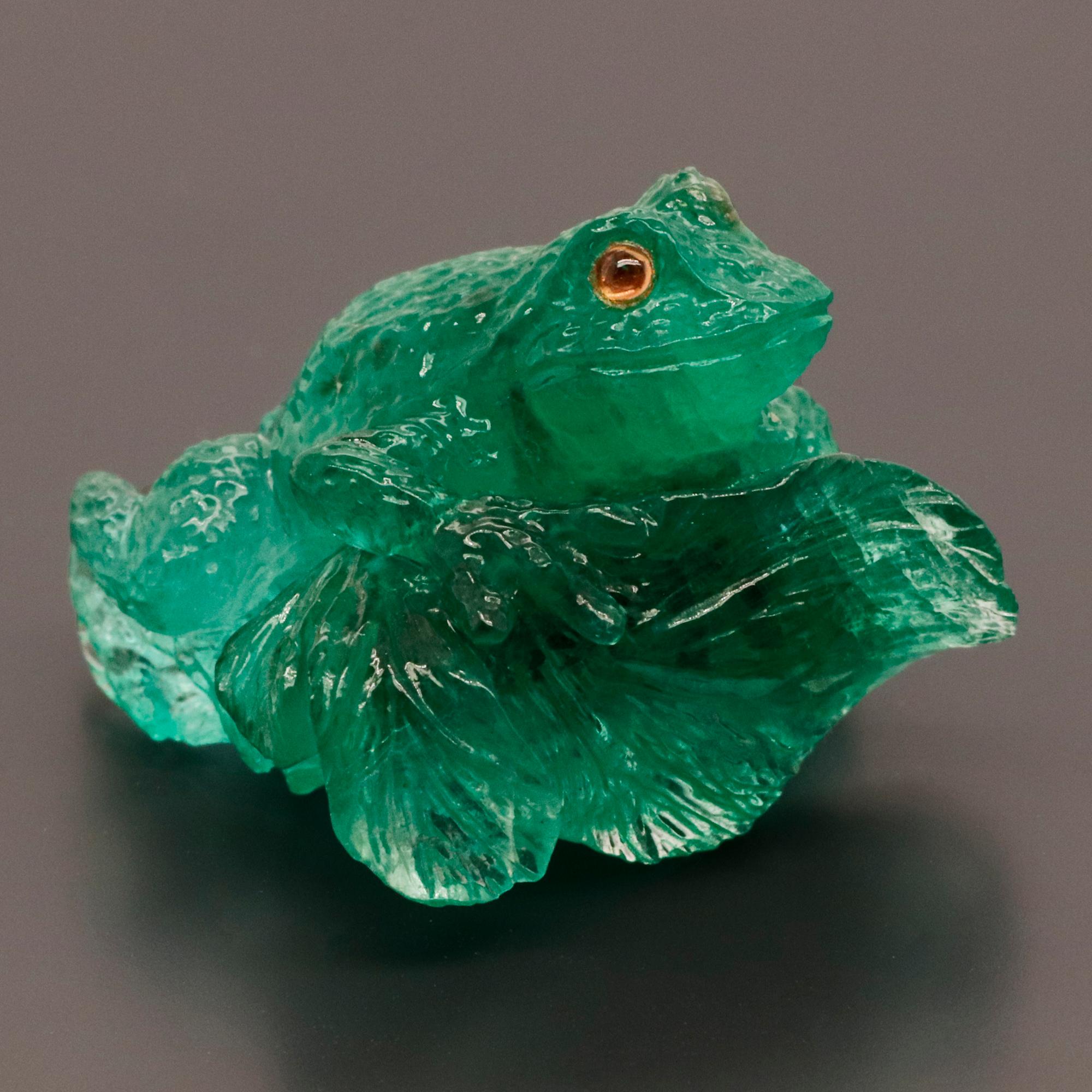 Ein kunstvoll geschwungener grüner Smaragd, der einen auf einem Blatt sitzenden Frosch darstellt.
Frösche werden im Allgemeinen als Symbol für Glück und Gesundheit angesehen. In vielen Kulturen und Glaubensrichtungen verkörpern Frösche vor allem