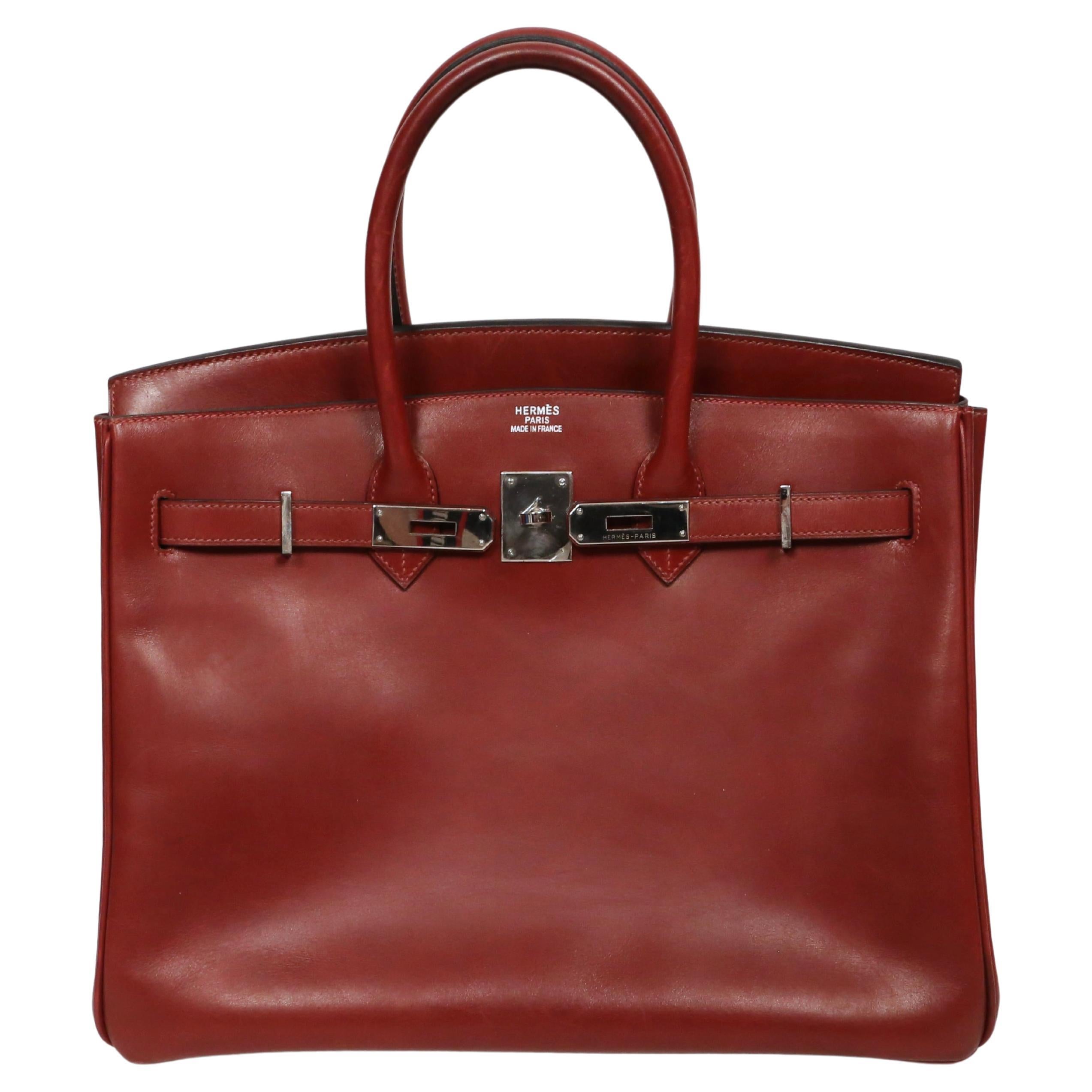 Very rare and beautiful 35 cm Rouge box leather Birkin bag from Hermès dating to 2005 . 

Color is a deep red-burgundy and the hardware is palladium plated (silver toned). 

The dimensions of the bag are approximately 14