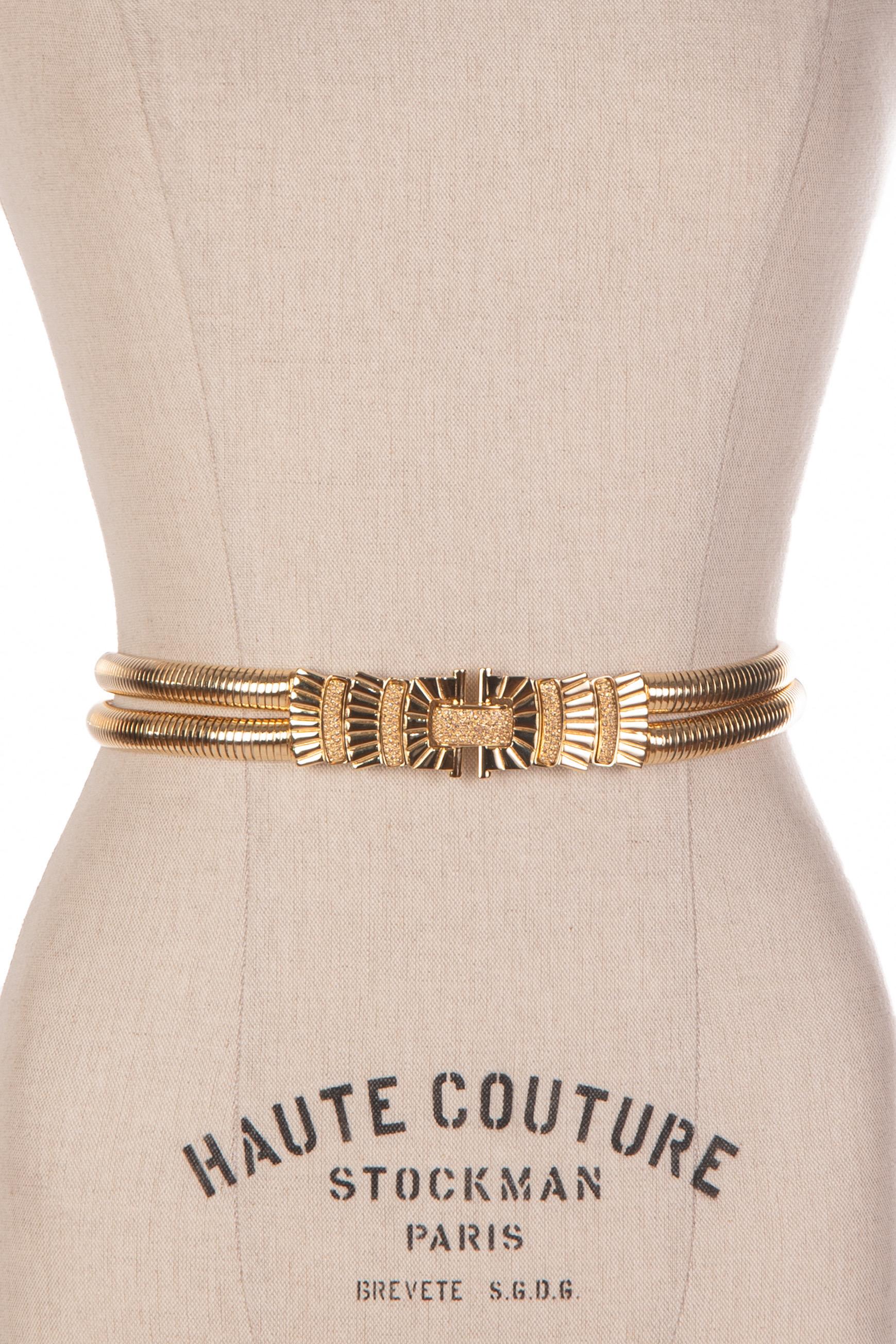 Synonymous with American luxury, Judith Leiber handbags and accessories are stylish, sophisticated and often whimsical.

This is an eye-catching and elegant signed and dated Judith Leiber gold tone double serpentine strap metal belt. The beautiful