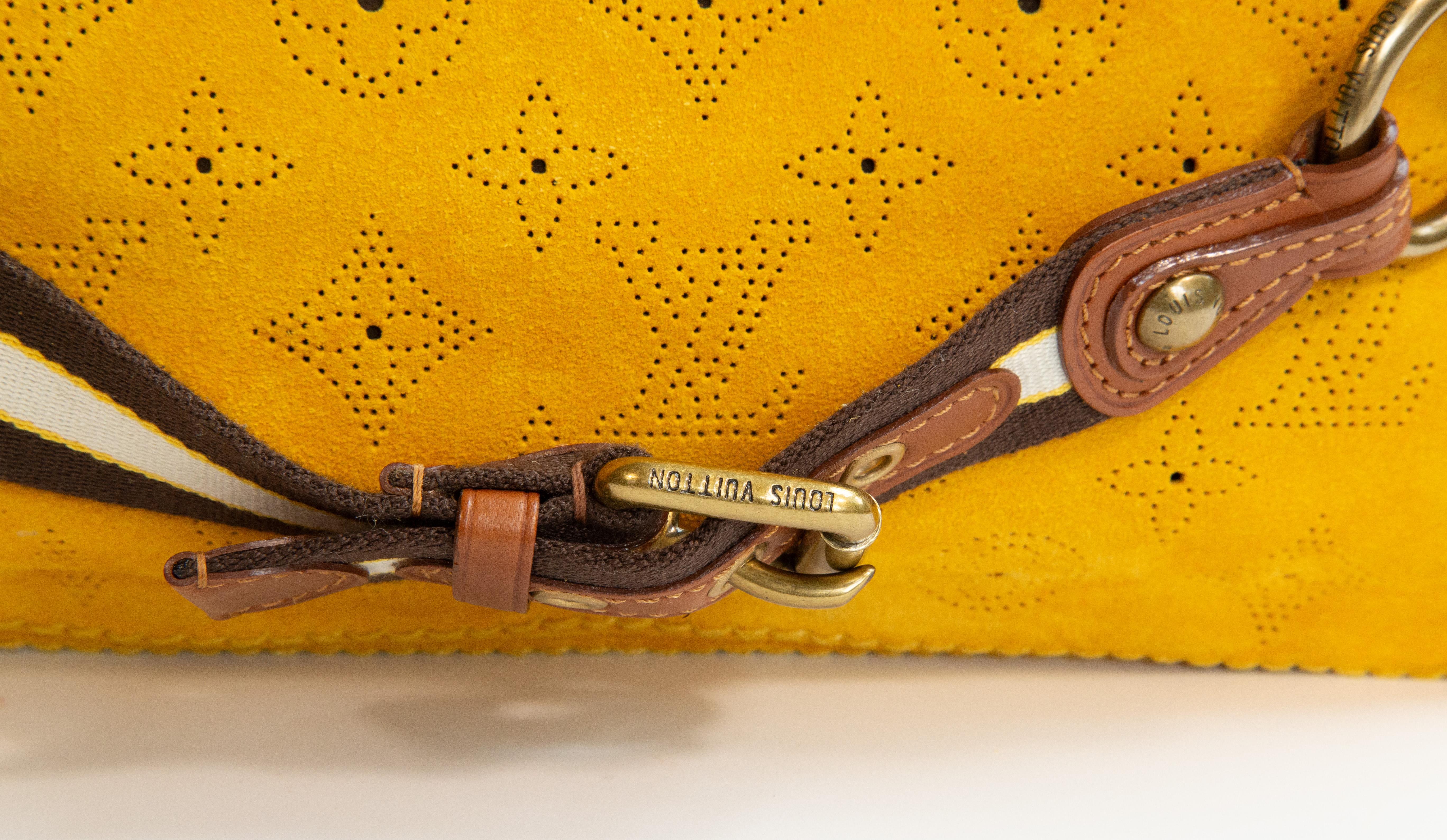 Louis Vuitton Mahina Onatah PM shoulder bag/clutch made of yellow suede with perforated LV monogram. The hardware is old gold toned and the shoulder strap is made of canvas with brown leather trim. The bag can be worn as a shoulder bag or a clutch
