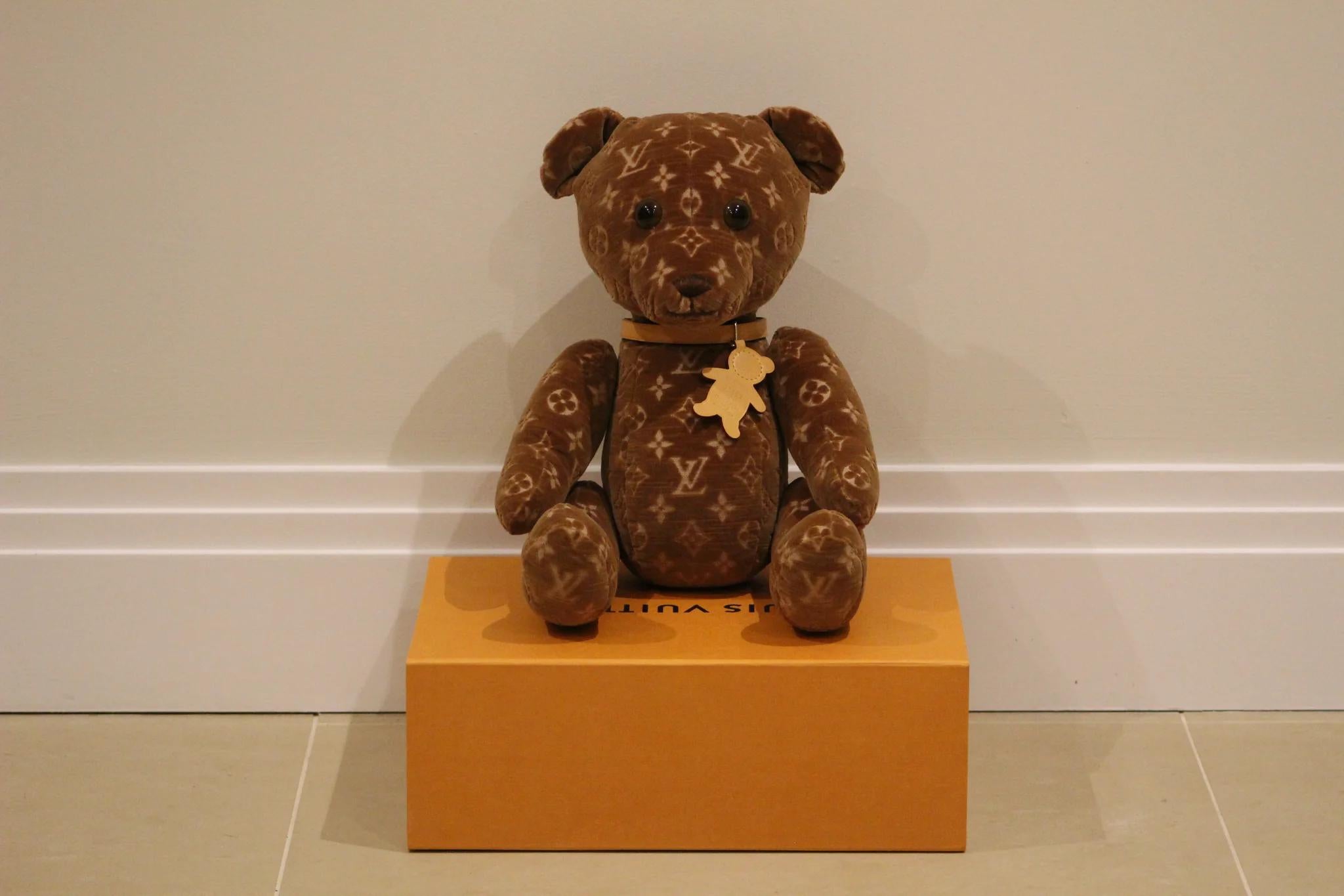Dive into the world of luxury and exclusivity with the 2005 Louis Vuitton Monogram Limited Edition VIP Doudou Teddy Bear. This captivating piece isn't just a teddy bear – it's a statement of elegance, design excellence, and rarity.

Originating from