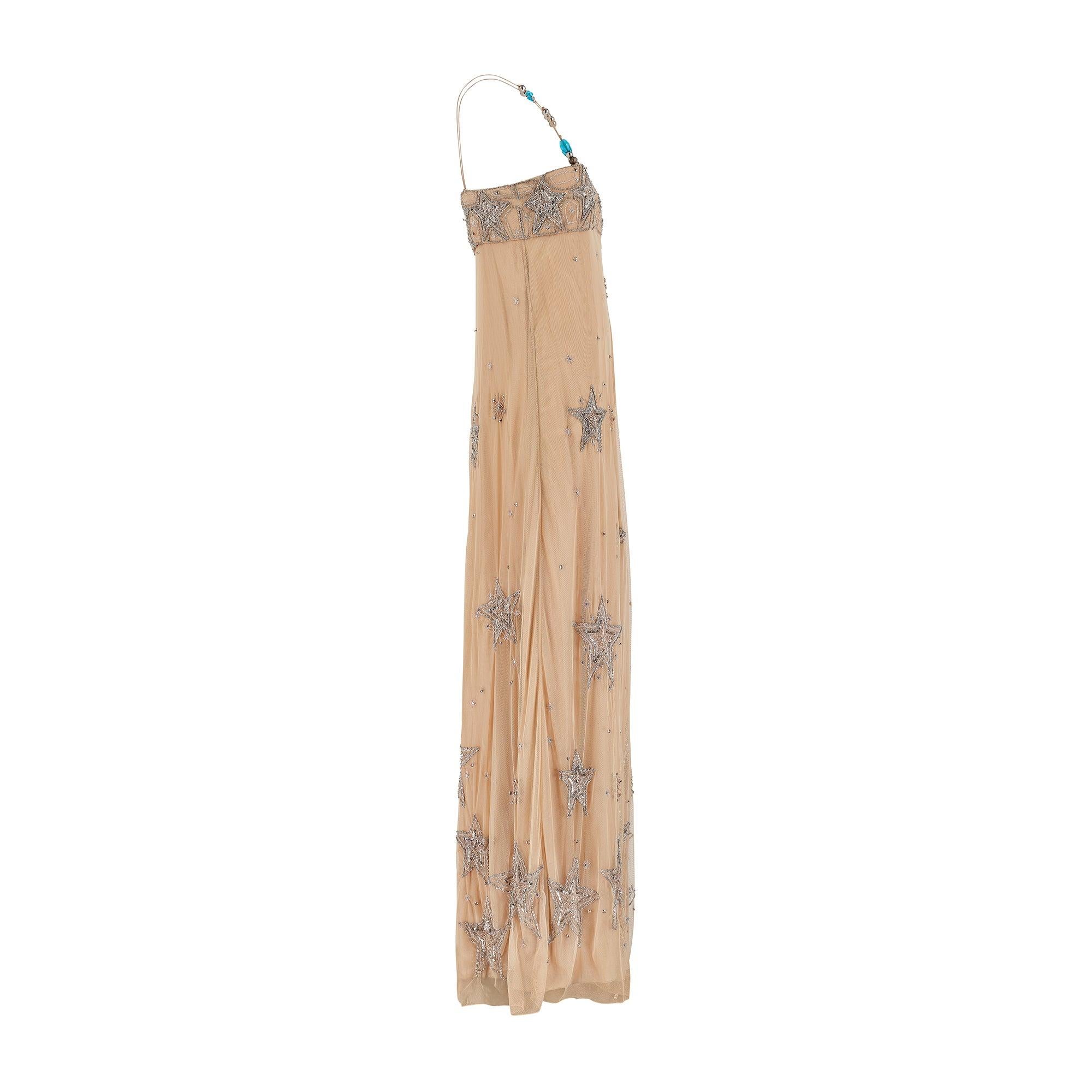 This whimsical Matthew Williamson maxi dress is crafted from nude silk and is decadently embellished in a celestial theme. A very similar design in a shift dress style walked the Spring 2005 runway (Look 33/38). Tailored from a layer of fine mesh