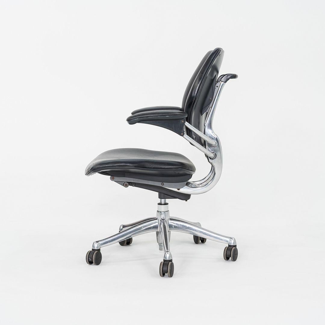 These are Freedom Task Desk Chairs, originally designed by Niels Diffrient in 1999. These particular examples were produced by Humanscale in the USA in the 2005. The chairs features an aluminum 5-star base and are upholstered in a black leather. The