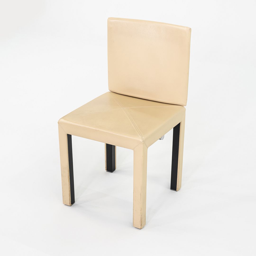 These are Arcadia armless dining chairs, initially designed by Paolo Piva for B&B Italia in 1989. These particular examples date to 2005. They feature a simplistic modern design with straight symmetrical lines, and have an expressive chromed-steel