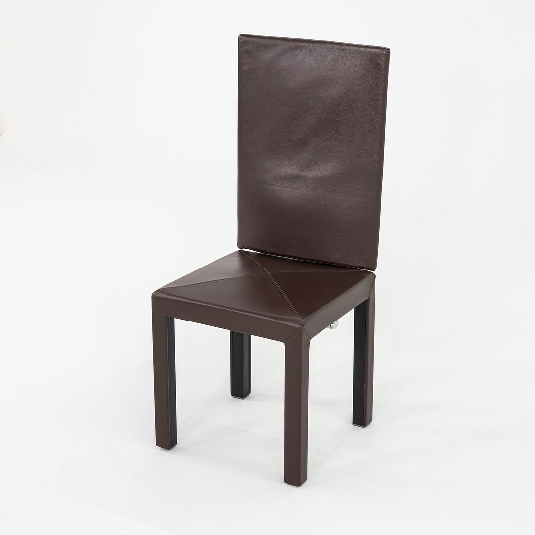 These are Arcadia armless high back dining chairs, initially designed by Paolo Piva for B&B Italia in 1989. These particular examples date to the 2000s. They feature a simplistic modern design with straight symmetrical lines, and have an expressive